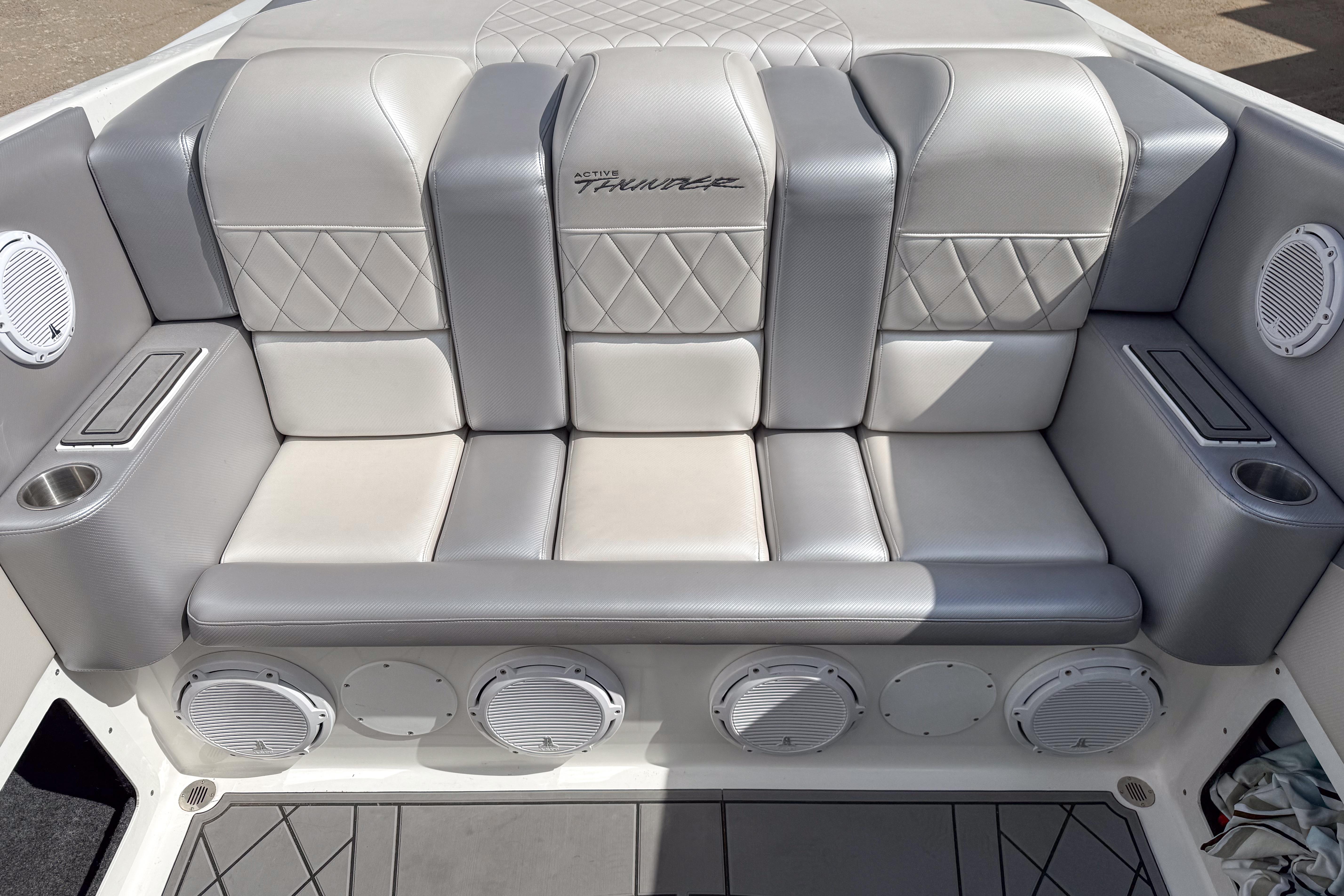 Luxurious seating in a 2002 Active Thunder 37 boat, featuring premium upholstery and integrated speakers.