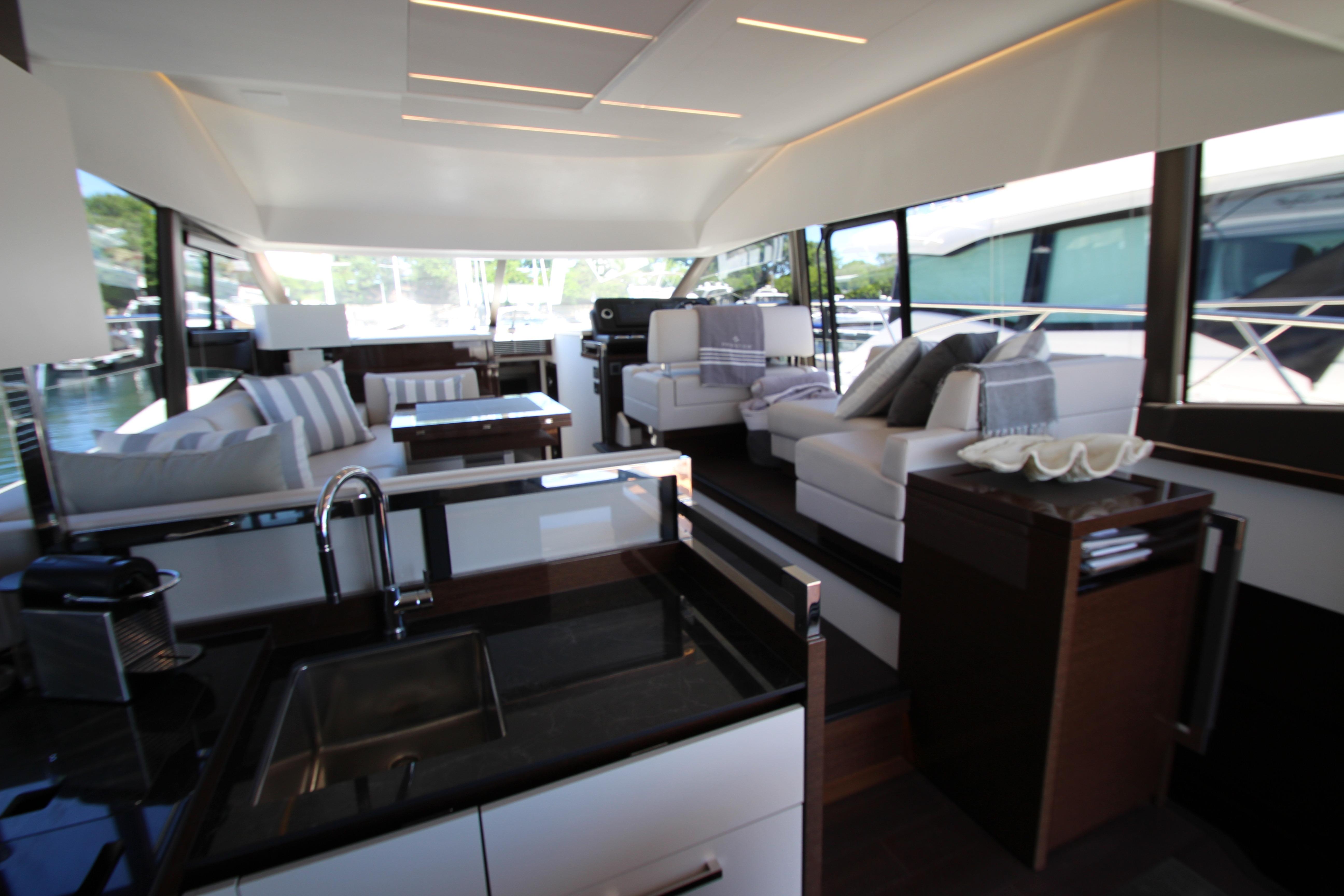 Luxurious interior of 2022 Prestige 520 yacht with modern furnishings and sleek design.
