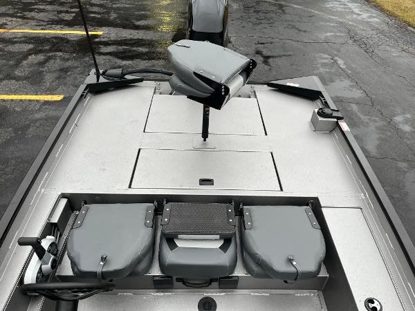 2024 Lowe Legacy boat interior with gray seating and storage compartments.