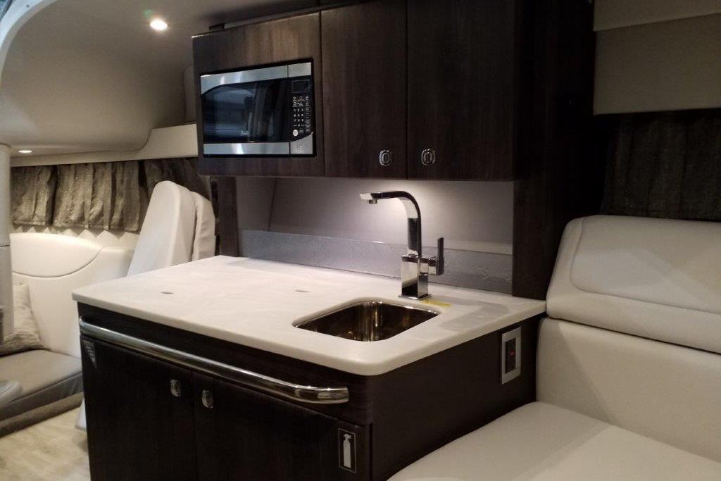Interior of 2021 Formula 350 Sun Sport boat with kitchenette and seating area.