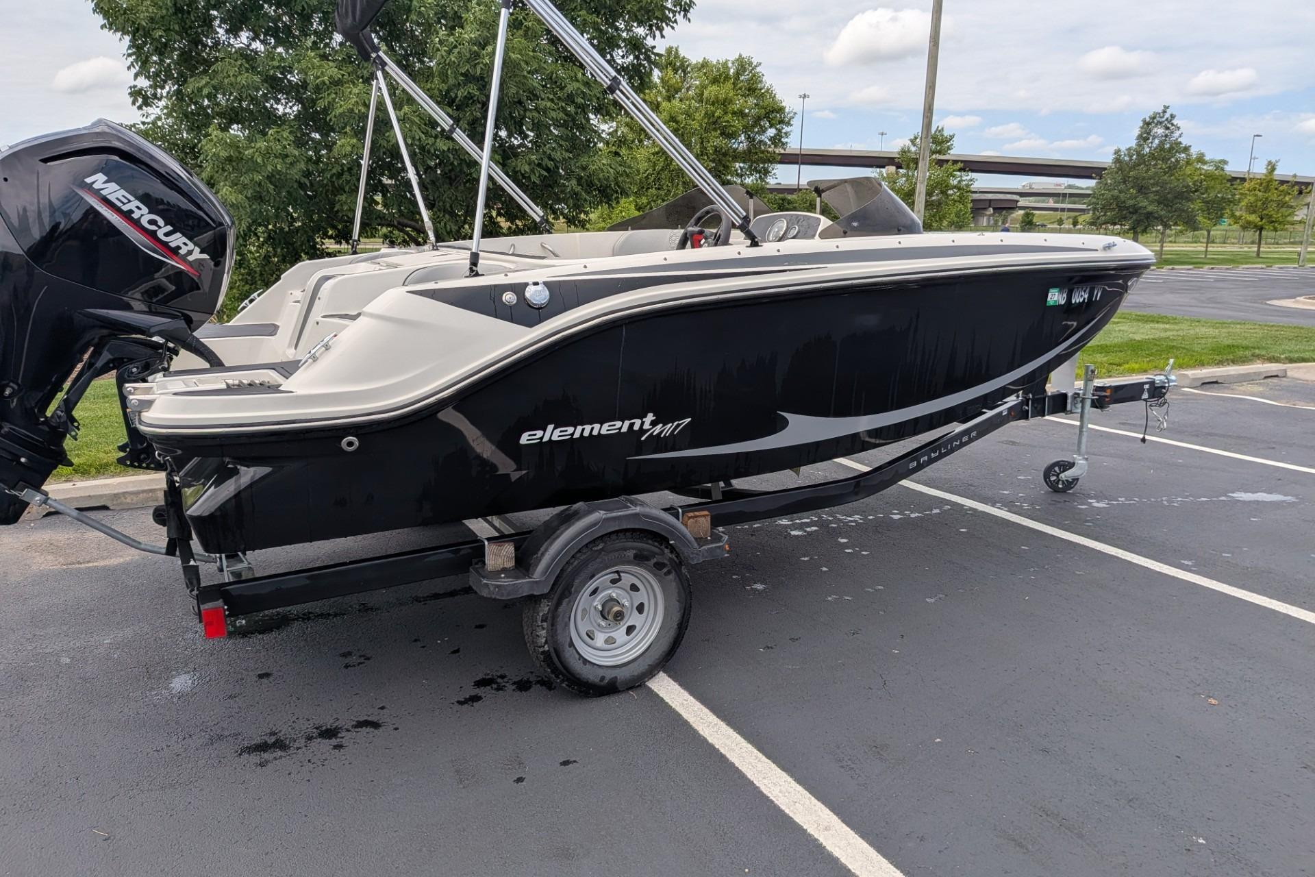 2023 Bayliner Element M17 boat on trailer in parking lot.