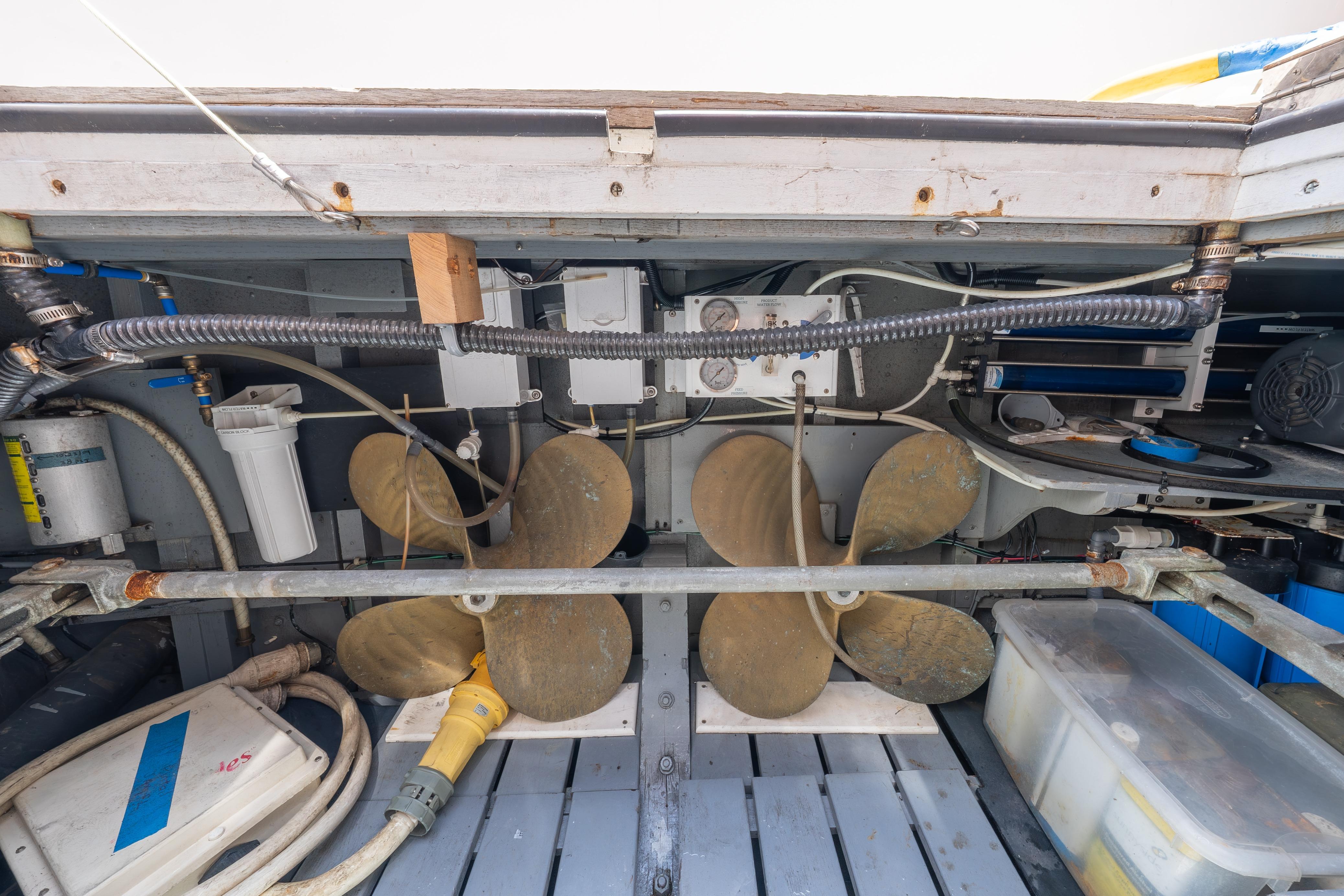 Engine room of a 1963 Trumpy Classic boat with propellers and mechanical components.