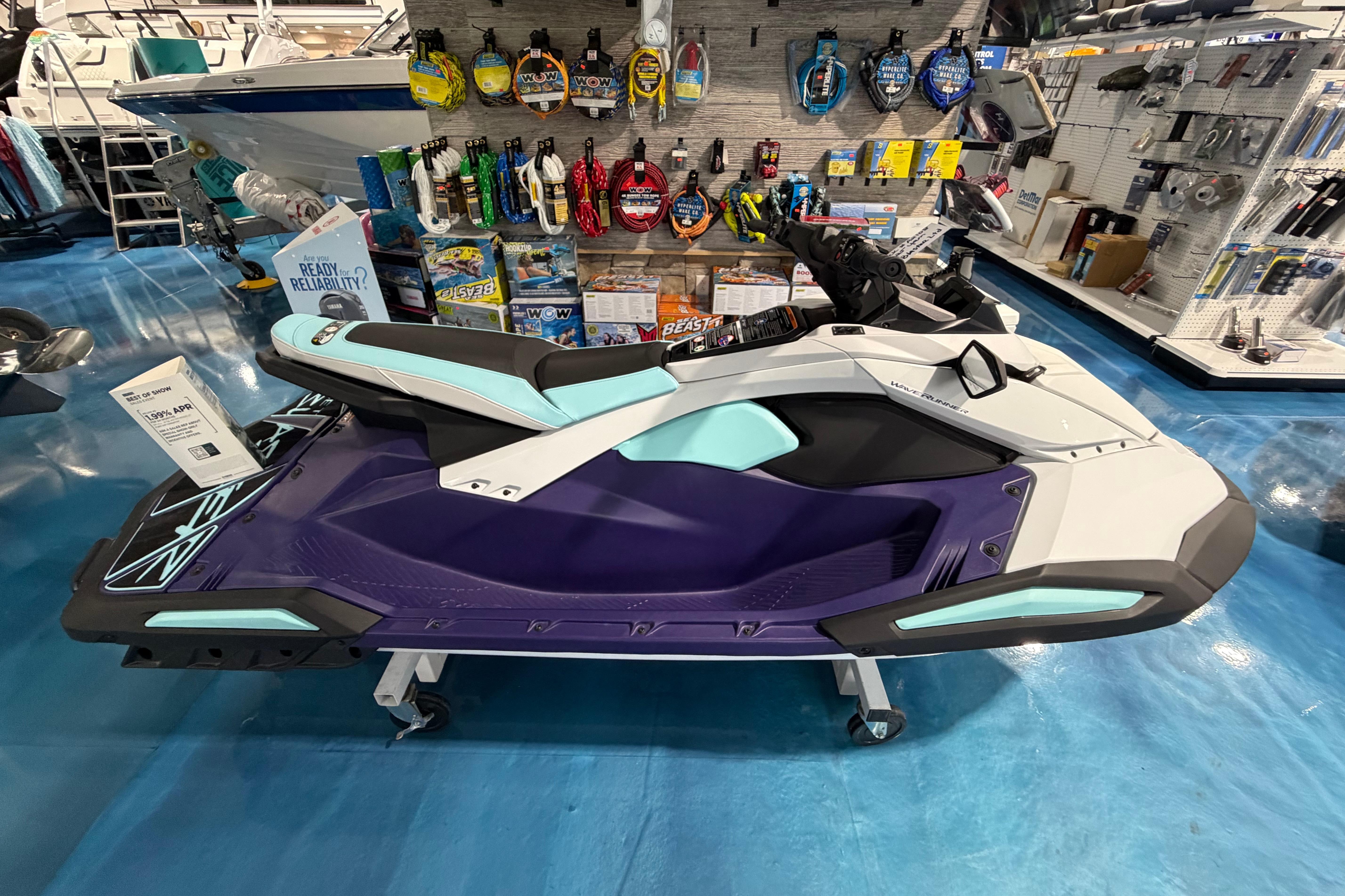2025 Yamaha WaveRunner JetBlaster displayed in a showroom with accessories on shelves.
