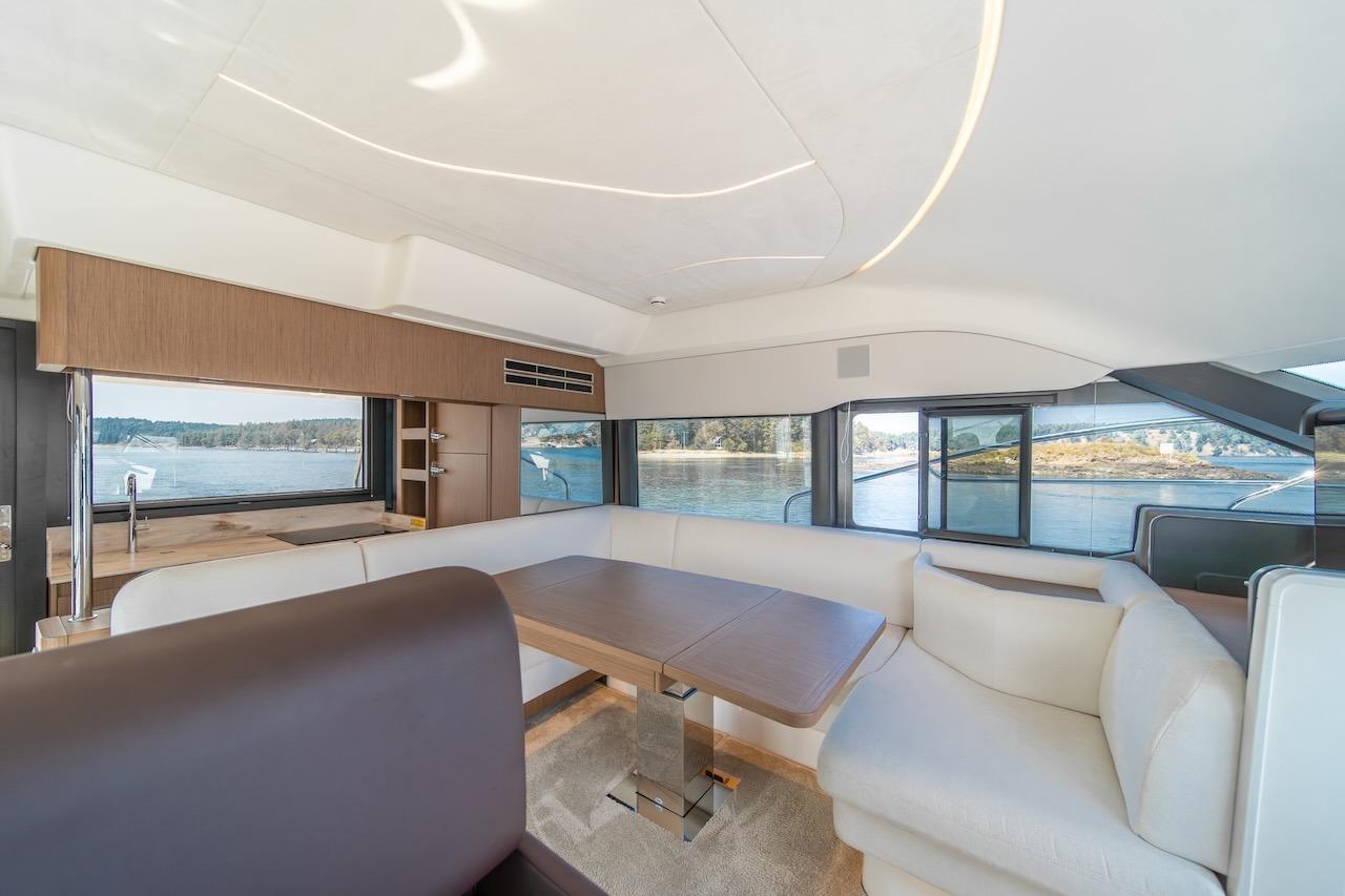 Luxurious interior of 2025 Prestige F4.9 yacht with panoramic windows and elegant seating.