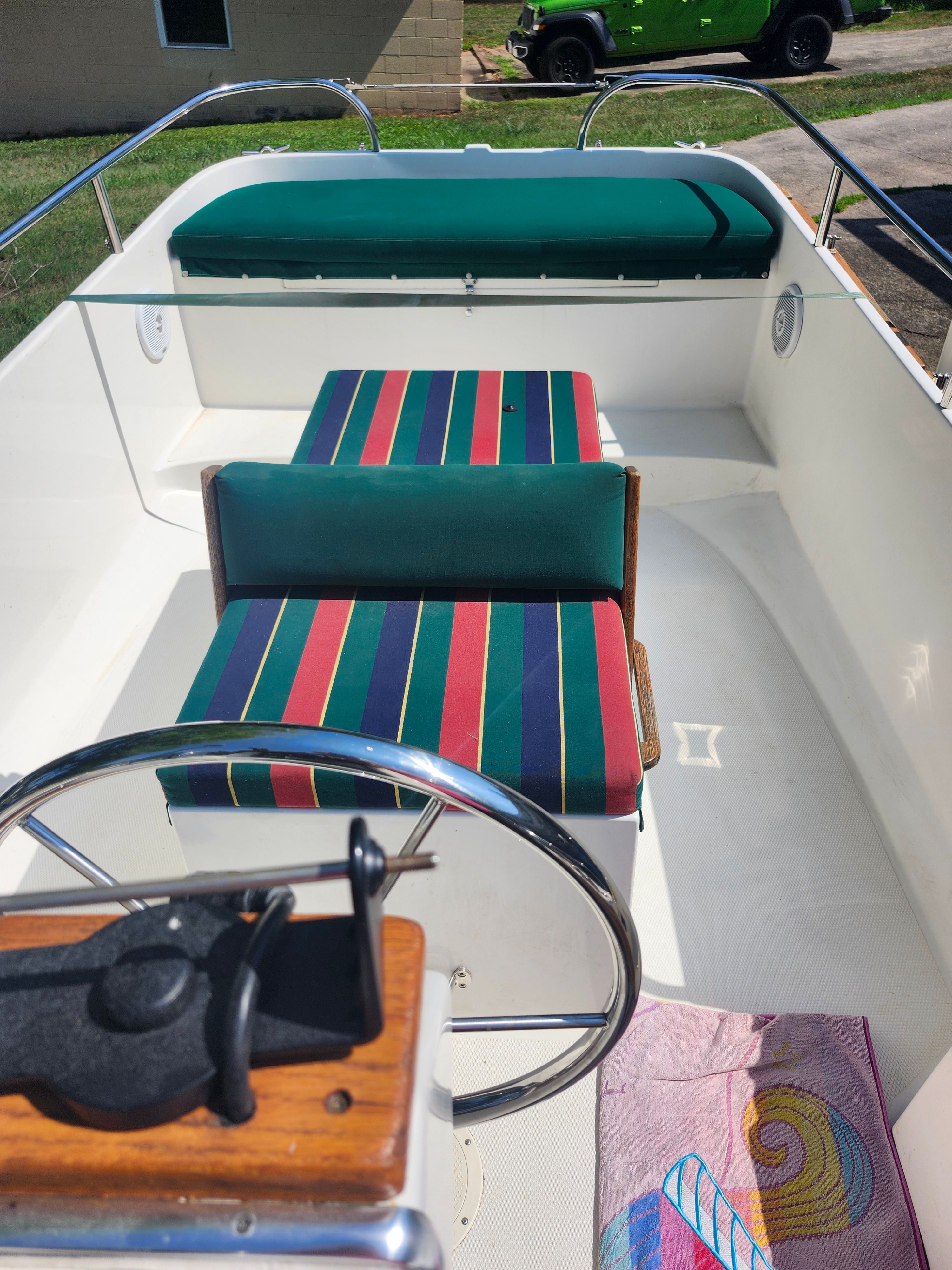 The image shows the interior of a 2000 Ranger Tugs Martini 21 Launch with striped seating.