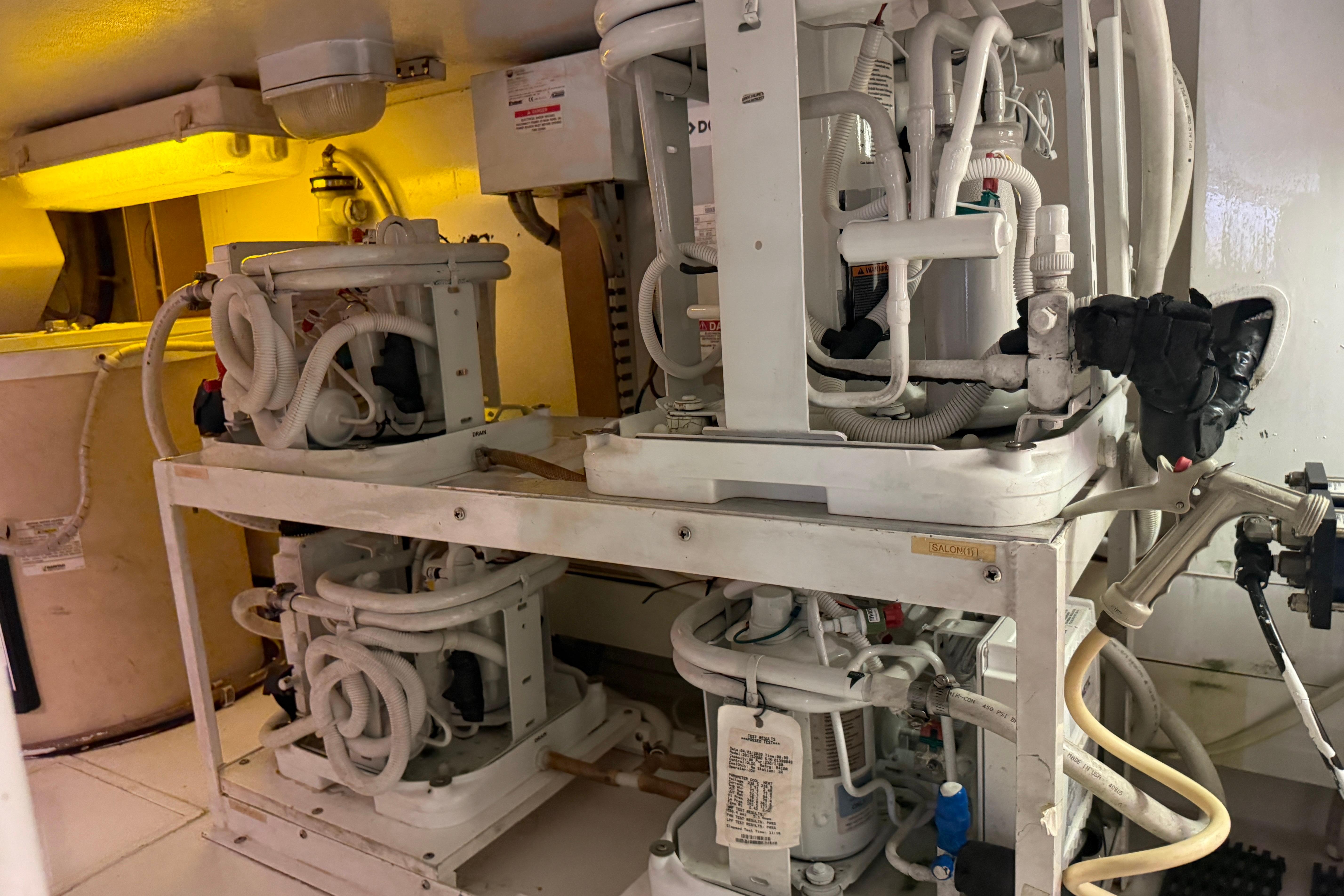 Engine room of a 2000 Viking 55 Convertible yacht with complex machinery and piping.