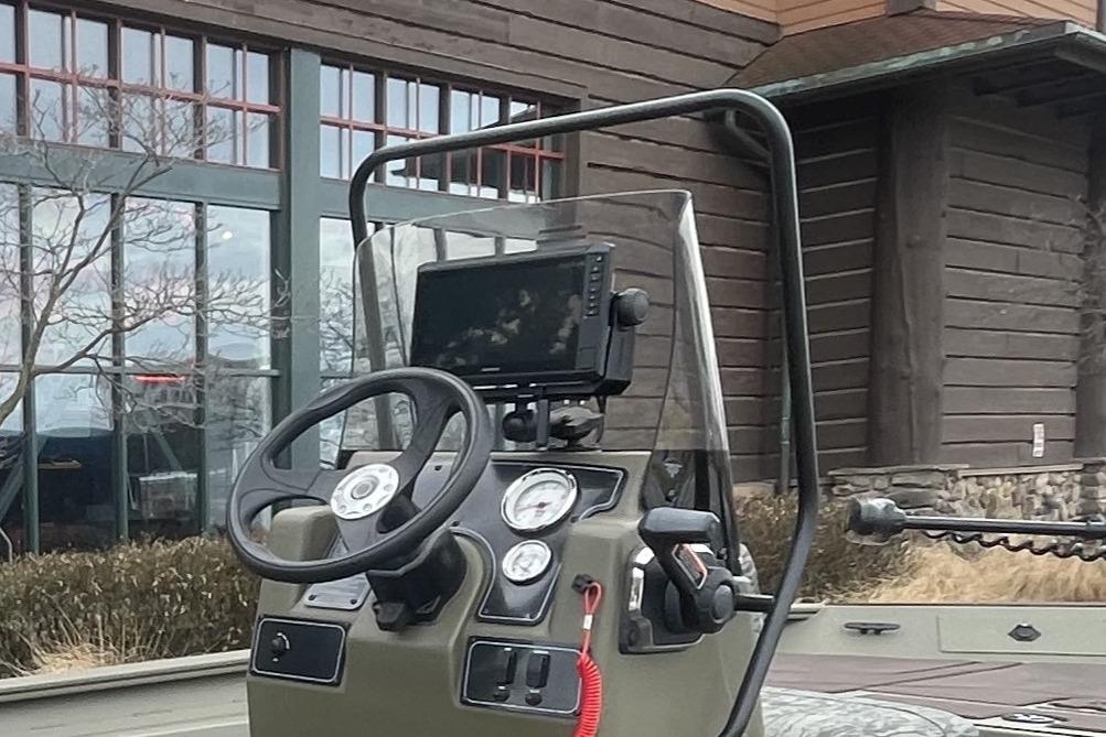 2026 Tracker Grizzly 1860 CC boat console with steering wheel and navigation display.