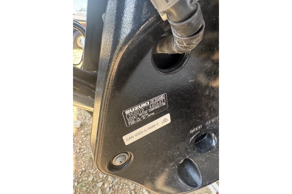 Close-up of a 2025 Majek 24 Reaper boat engine with Suzuki label.