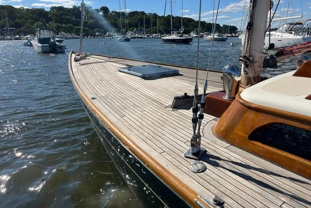 Sleek 2006 Morris 36 sailboat with wooden deck, docked in a serene marina.