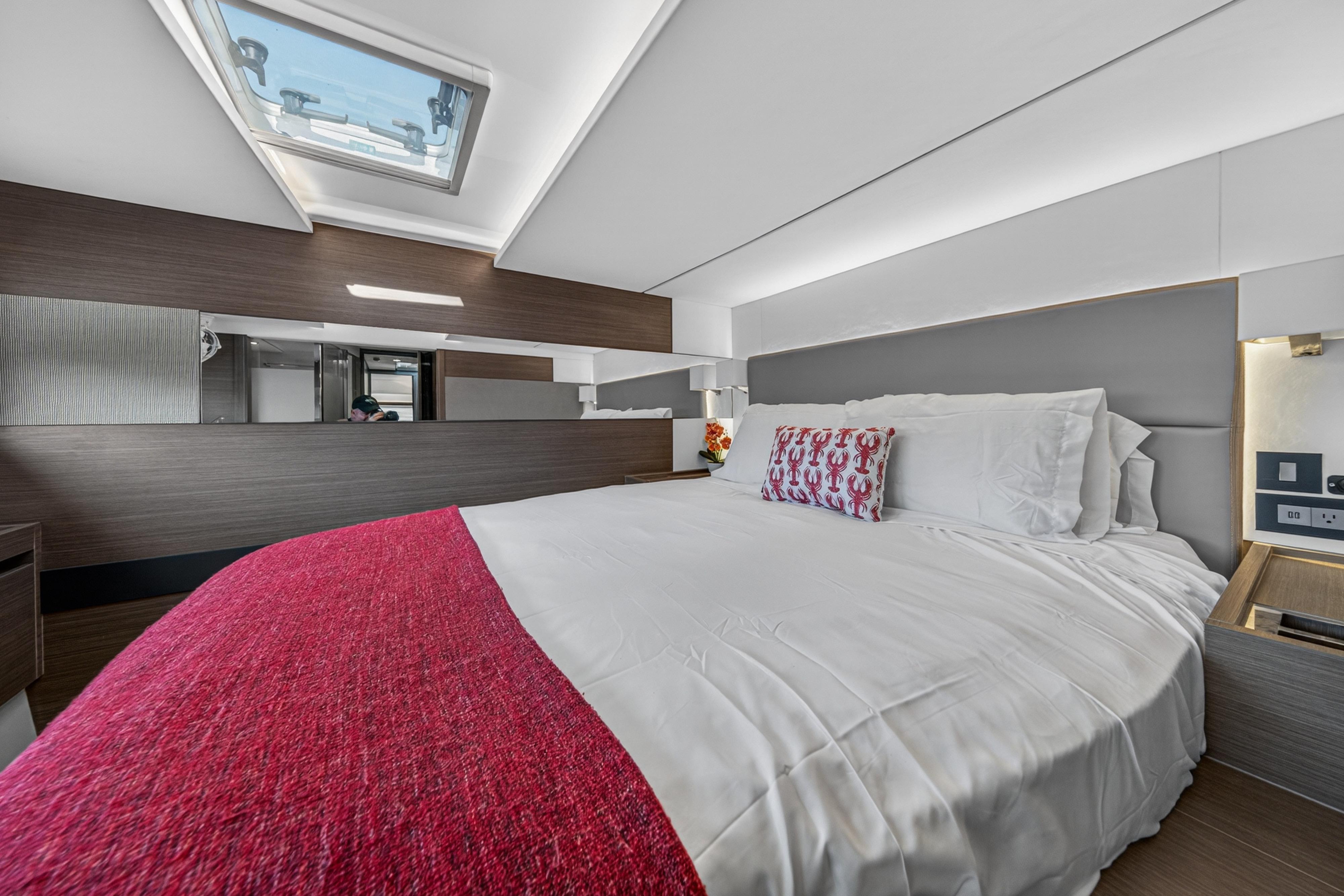 Luxurious bedroom interior of 2022 Leopard 53 Powercat yacht with skylight and modern design.