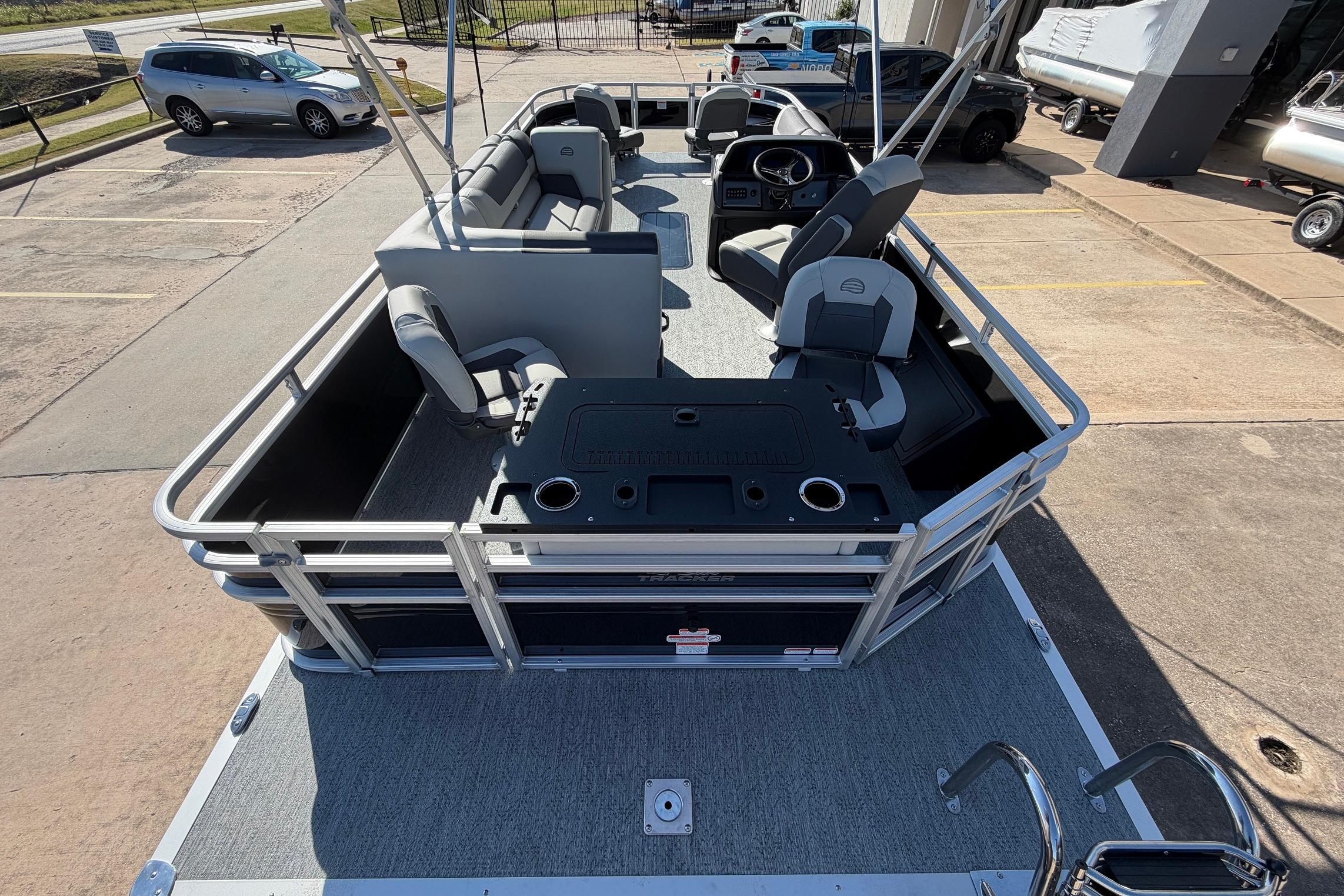 2026 Sun Tracker Fishin' Barge 22 XP3 pontoon boat with spacious seating and fishing amenities.