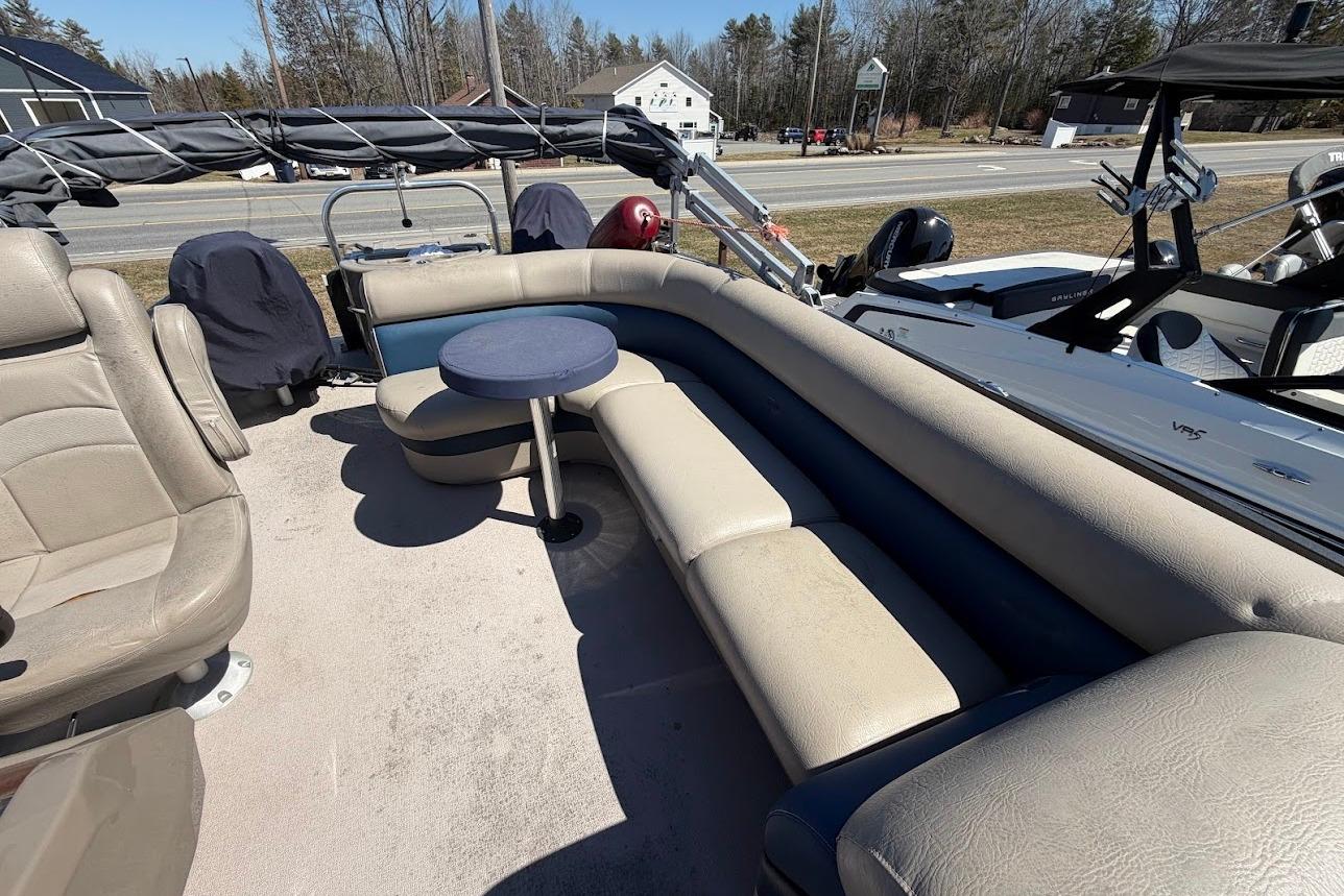 2013 Premier 221 Explorer boat interior with beige seating and small round table.