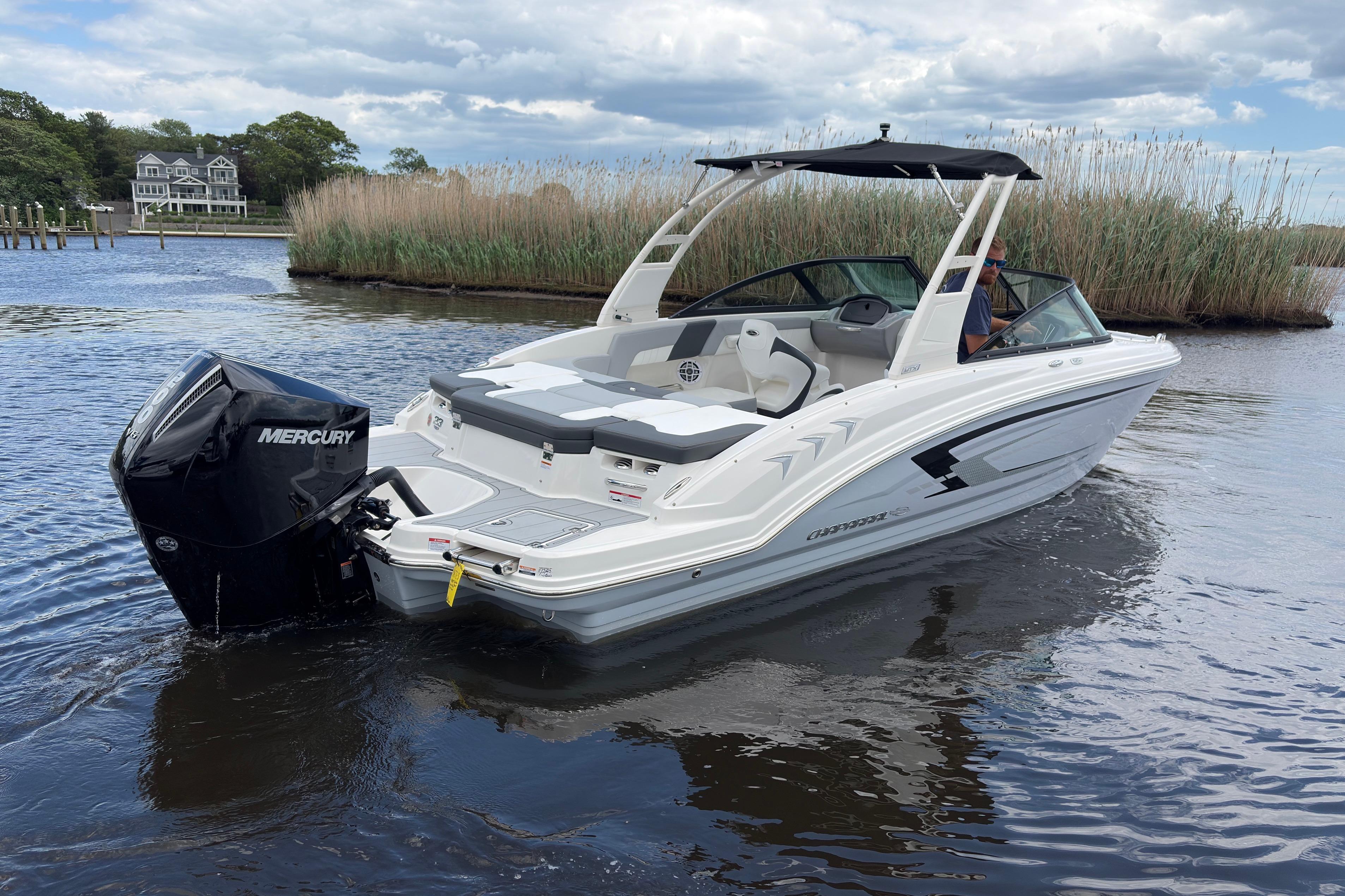 2026 Chaparral 23 SSi OB boat with Mercury outboard engine on calm water.