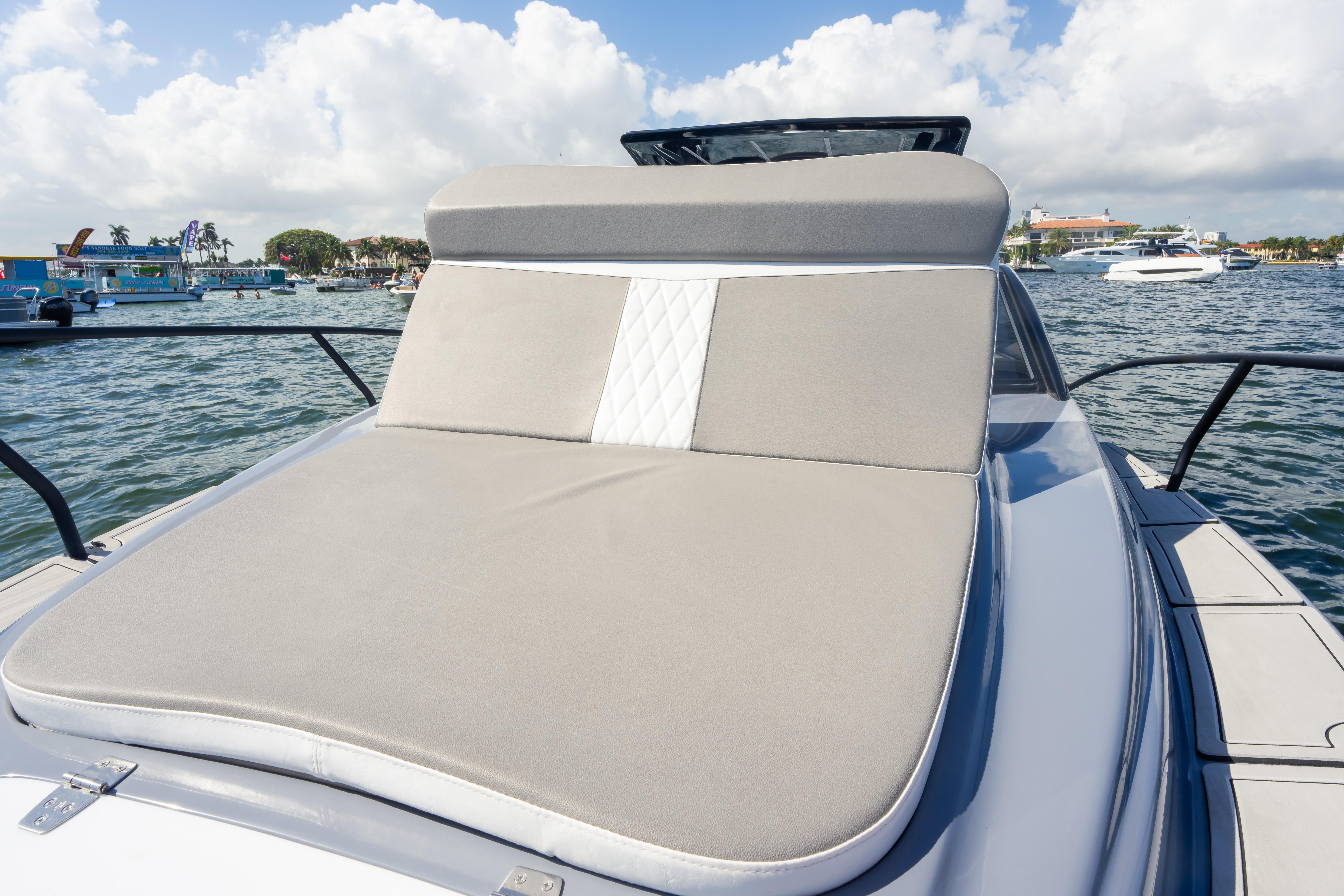 Luxurious 2026 Hanover 305 yacht with spacious sunbed on a sunny day at sea.