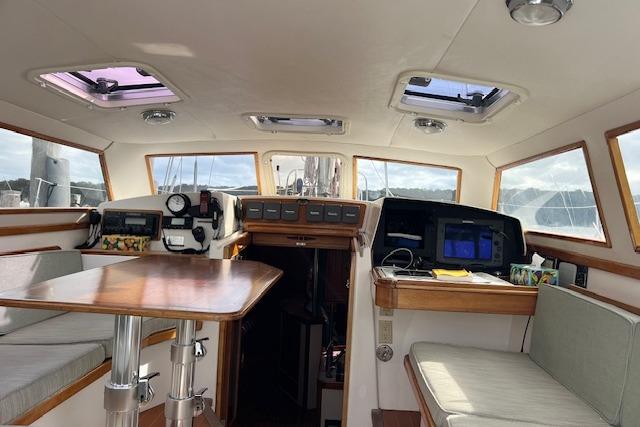 Interior of 1995 Little Harbor 51 Pilothouse yacht with navigation equipment and seating area.