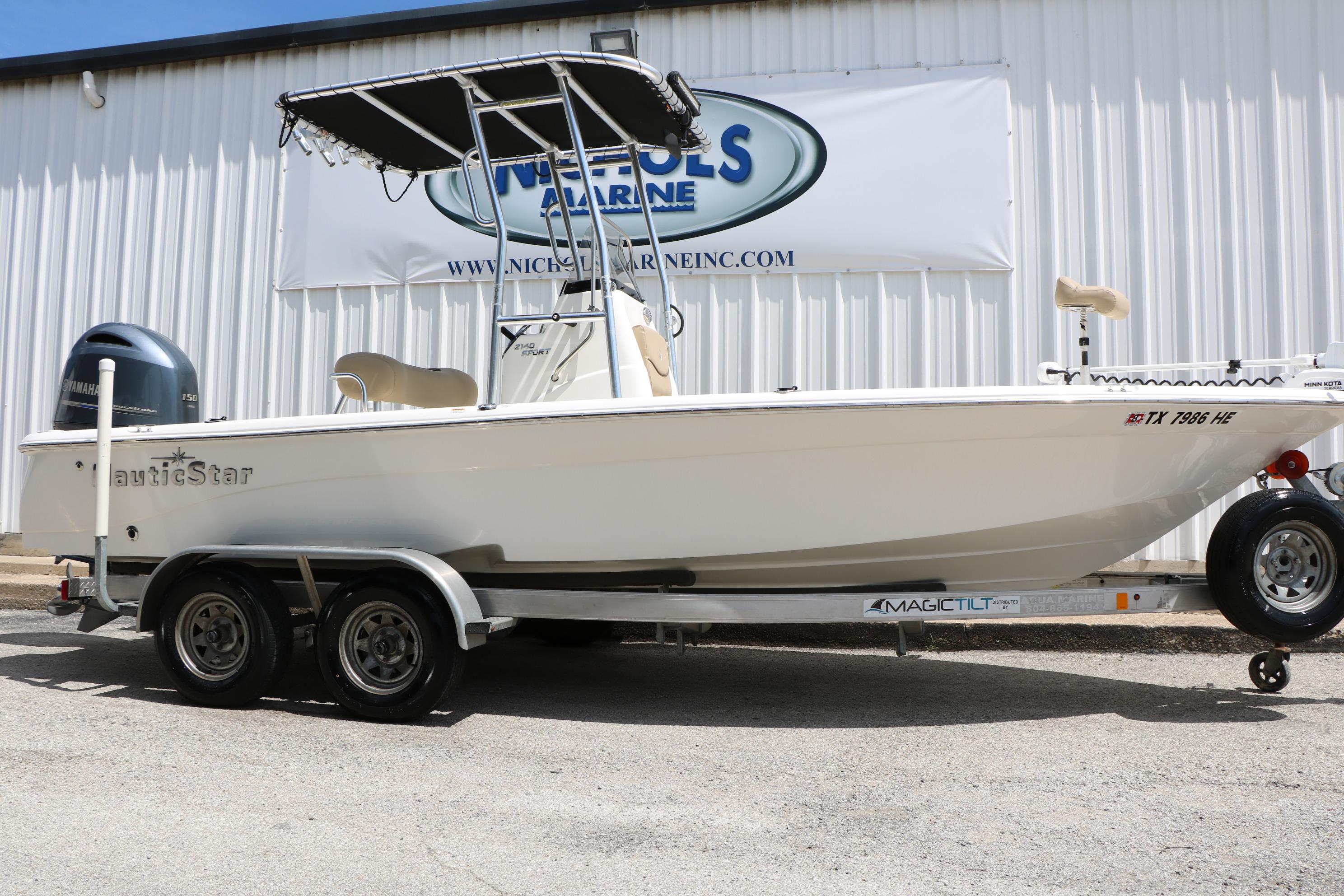 2020 NauticStar 2140 Sport boat on trailer outside dealership.