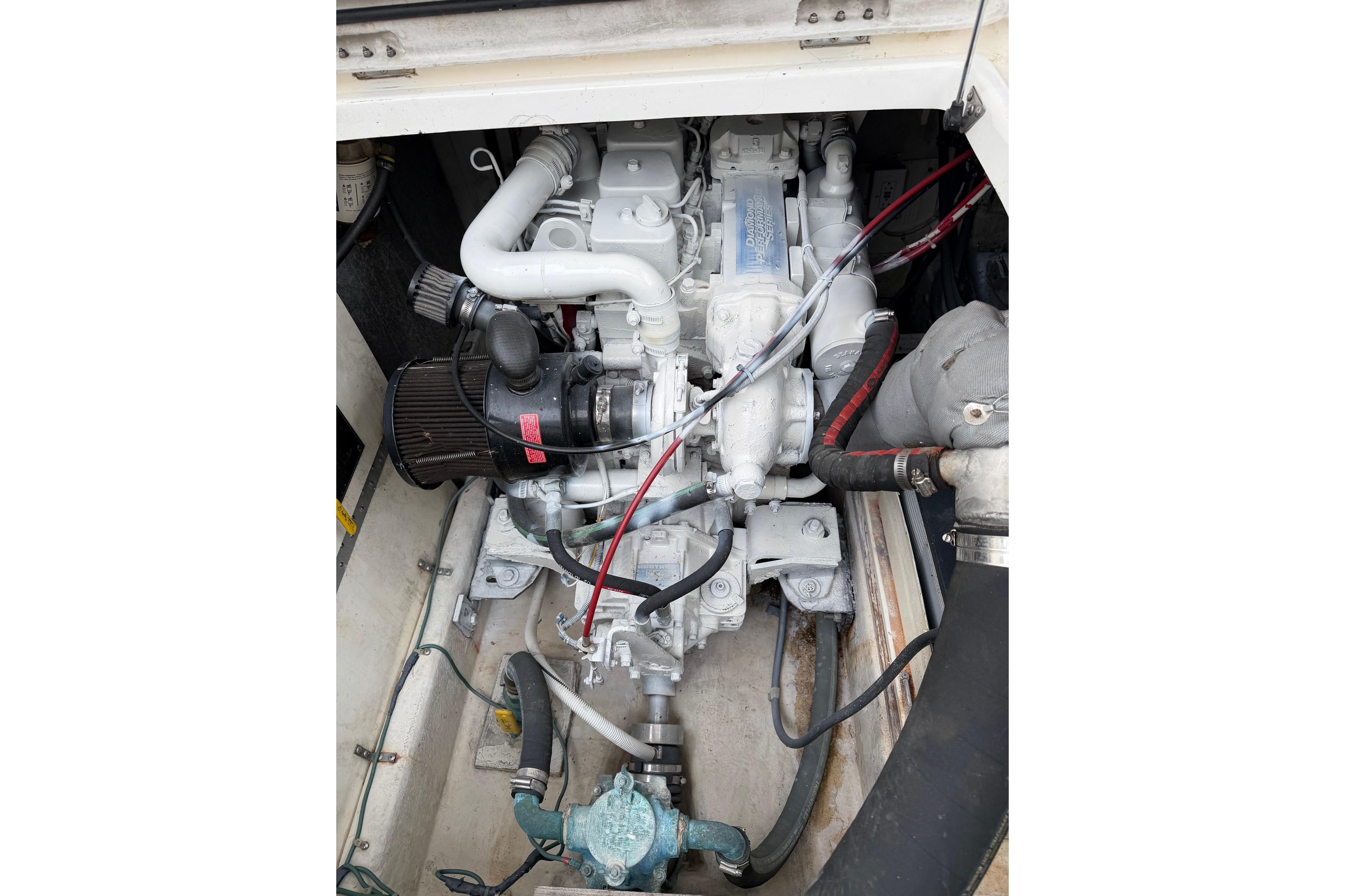 Engine compartment of a 1998 Bayliner 3388 Command Bridge Motoryacht, showcasing mechanical components.