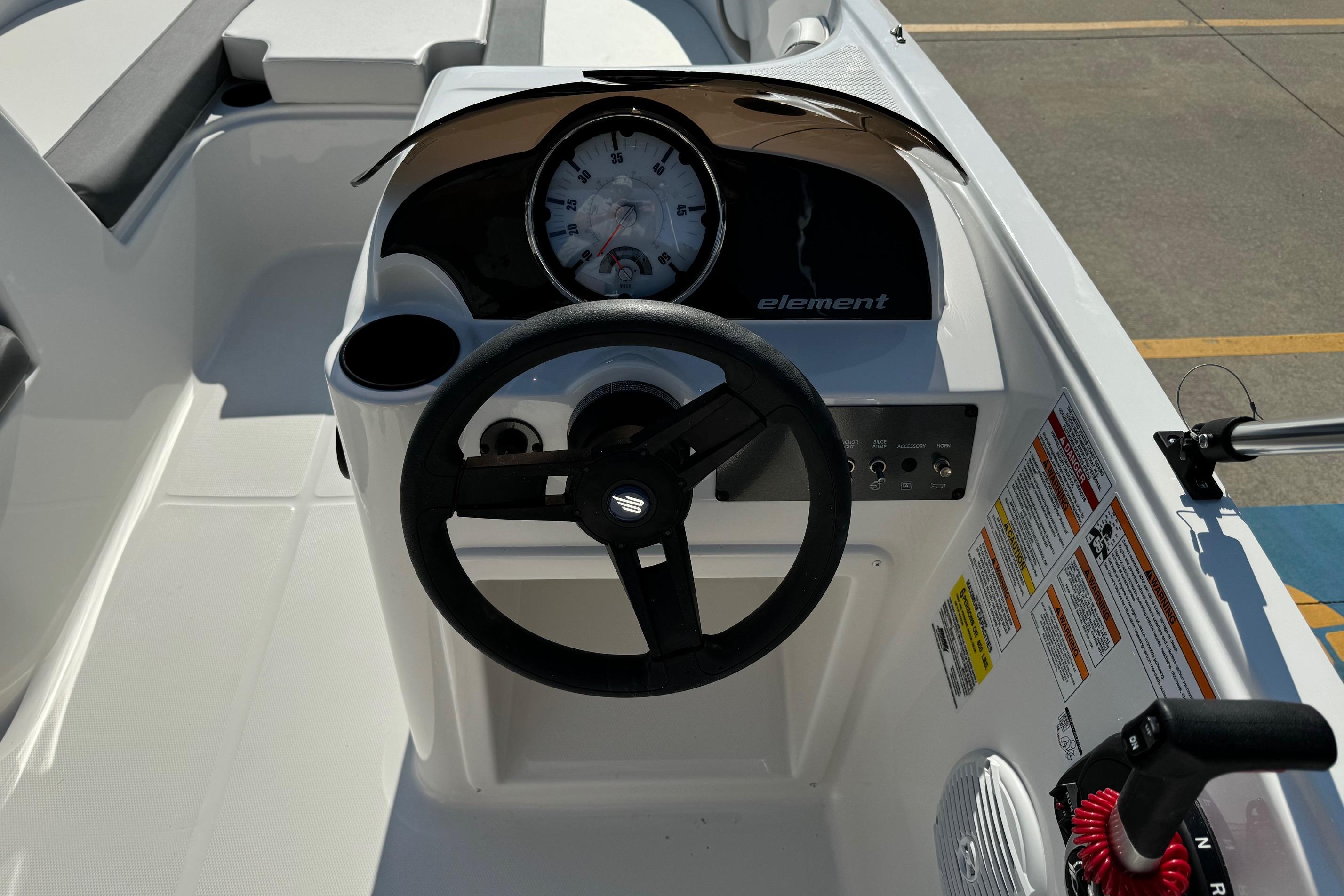 2025 Bayliner Element E16 boat dashboard with steering wheel and instrument panel.