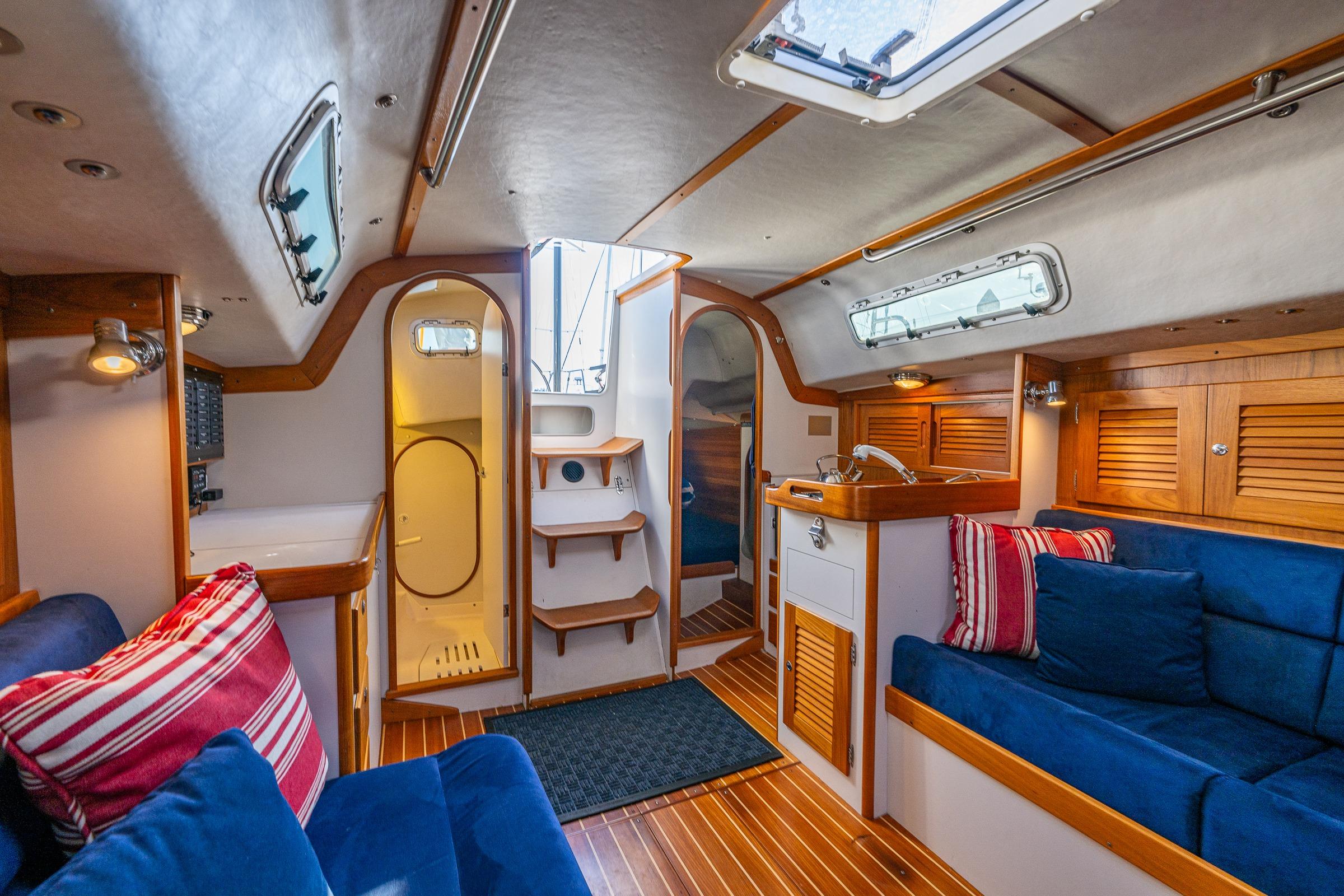 Interior of 2007 J Boats J/124 yacht with cozy seating and wooden accents.