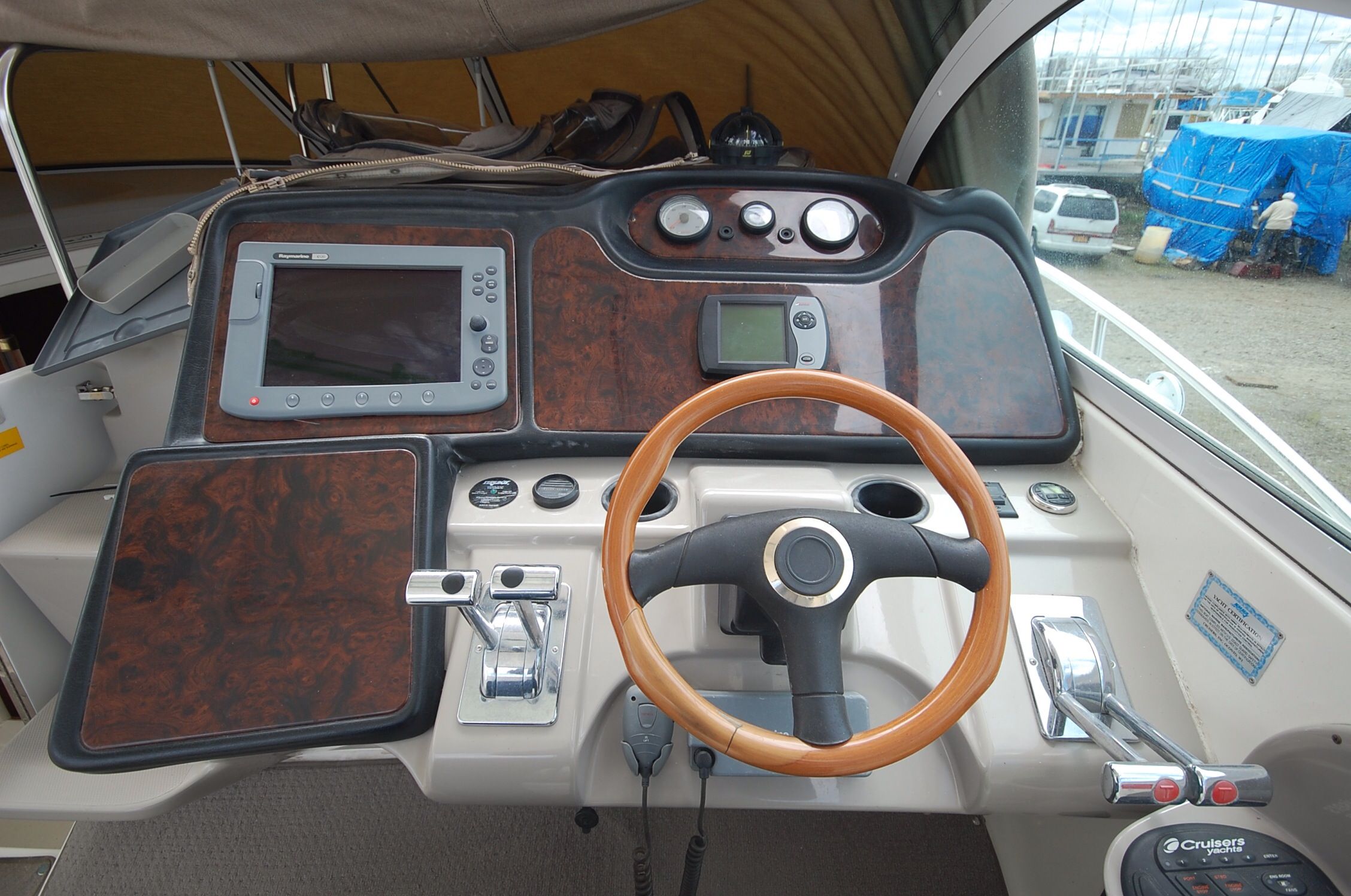 2004 Cruisers Yachts 3970 helm with wood paneling.