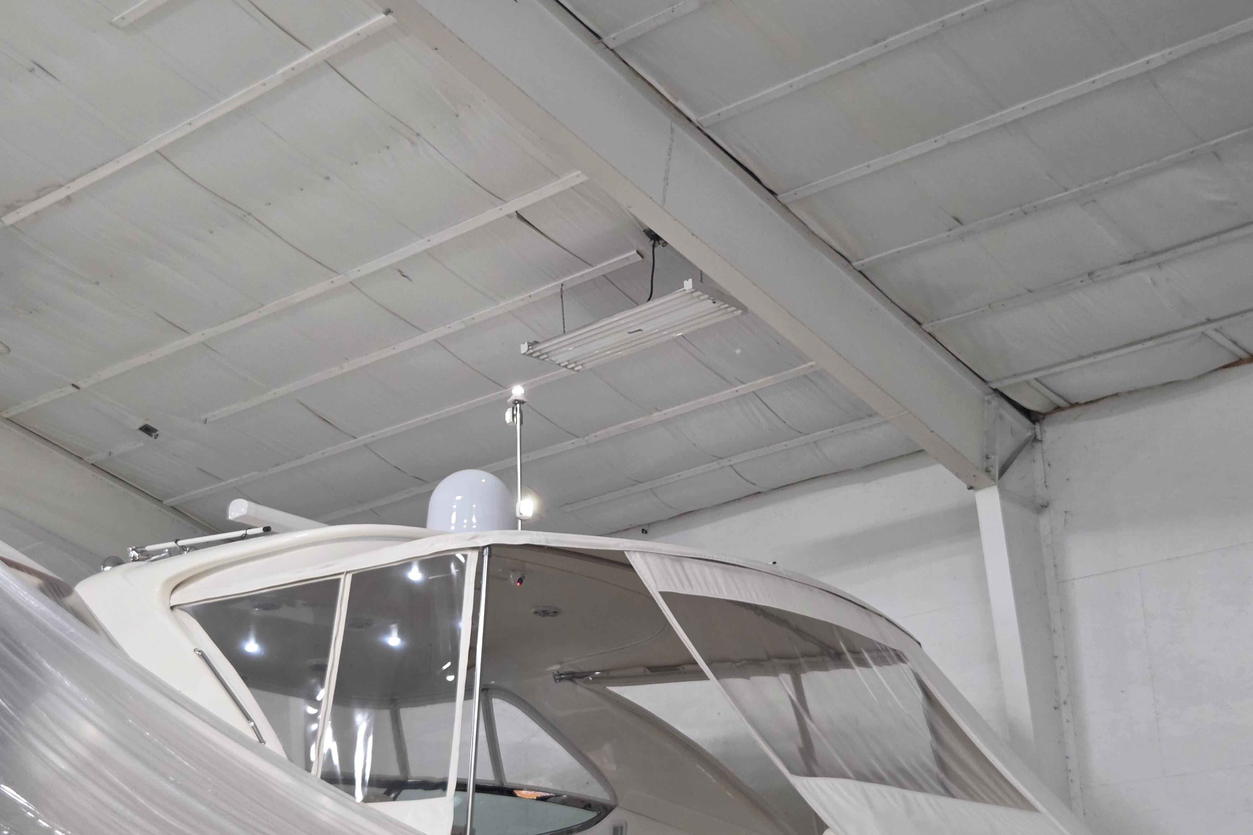 Sea Ray Sundancer 540 yacht, 2000 model, stored indoors under a high ceiling.