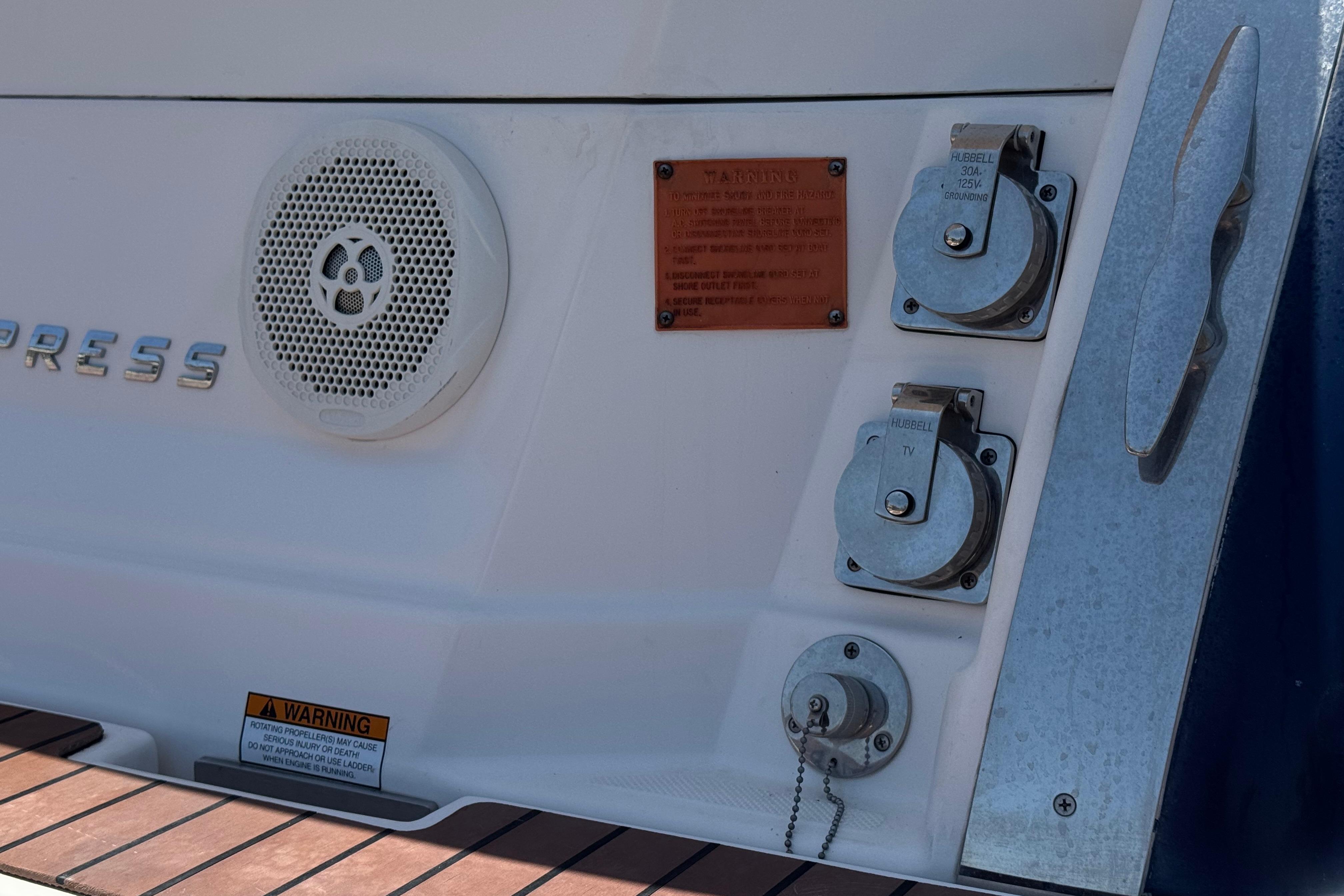 2013 Regal 28 Express boat stern with speaker, power outlets, and warning label.