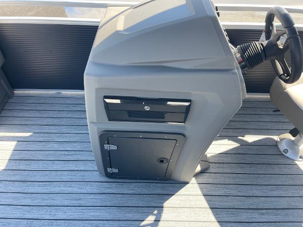 Control console of 2025 Armada Saphir 23CR boat with steering wheel and storage compartments.