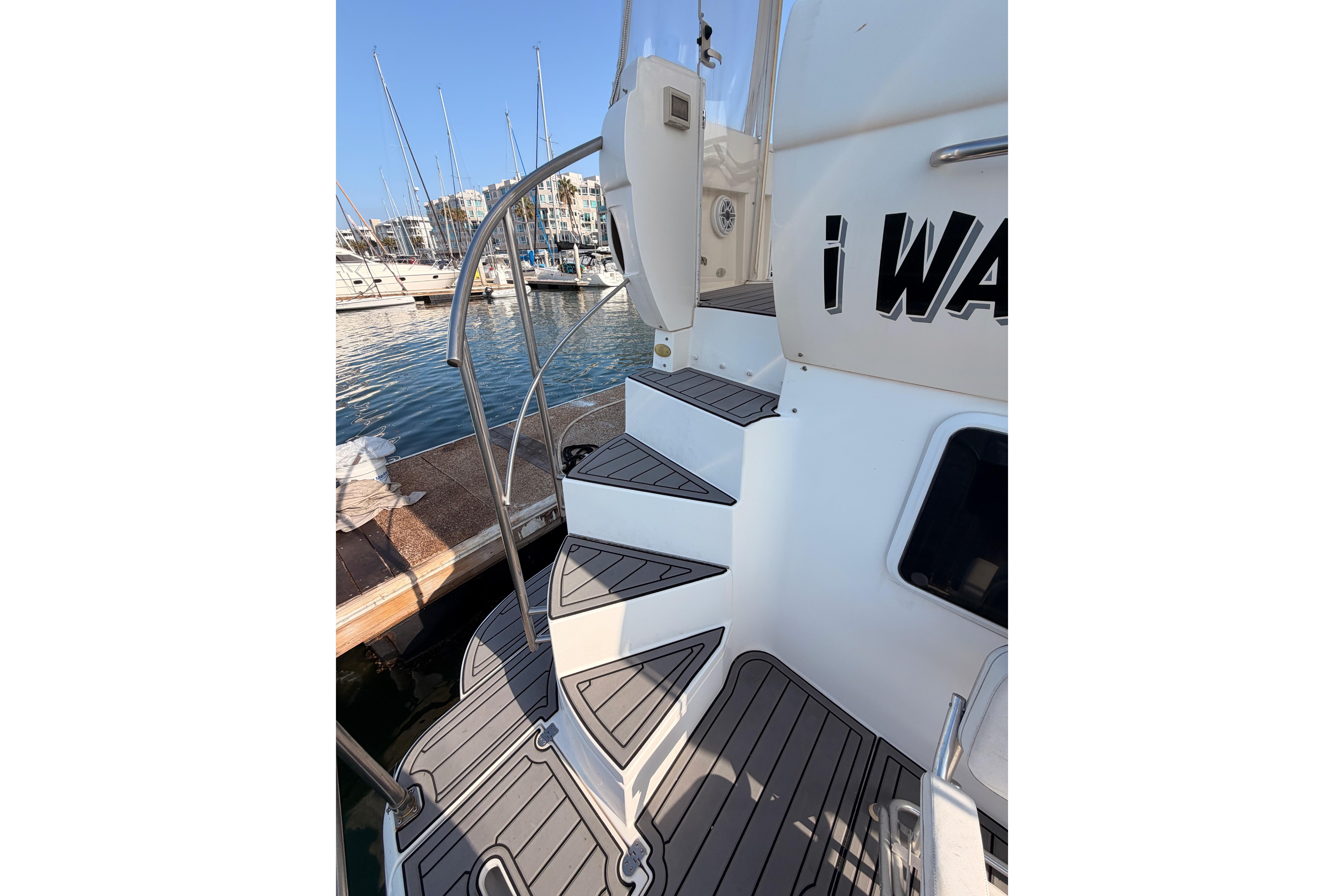 Staircase on 2005 Cruisers Yachts 405 Express Motoryacht, docked at marina.