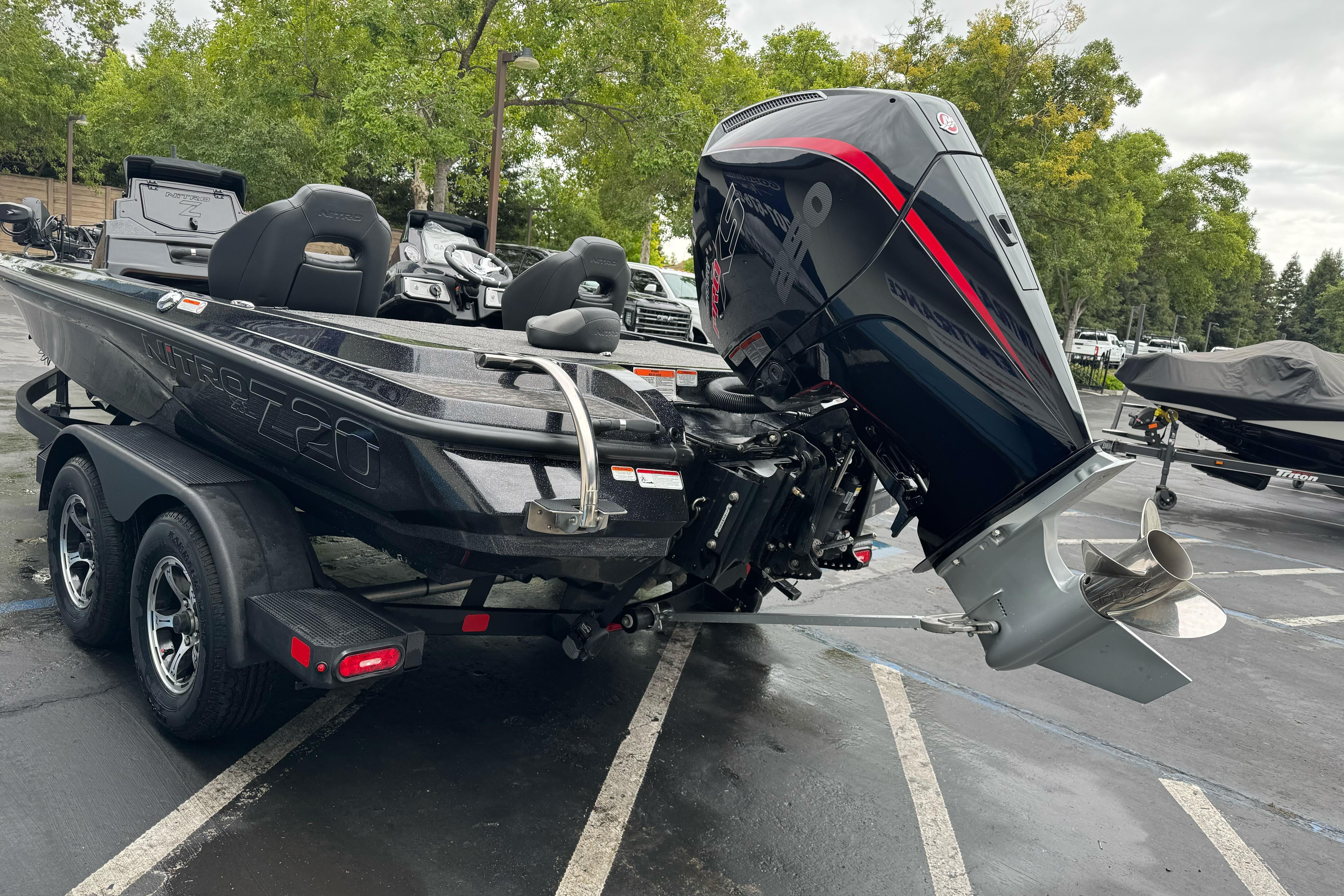 2026 Nitro Z20 XL Pro boat with powerful outboard motor in a parking lot.