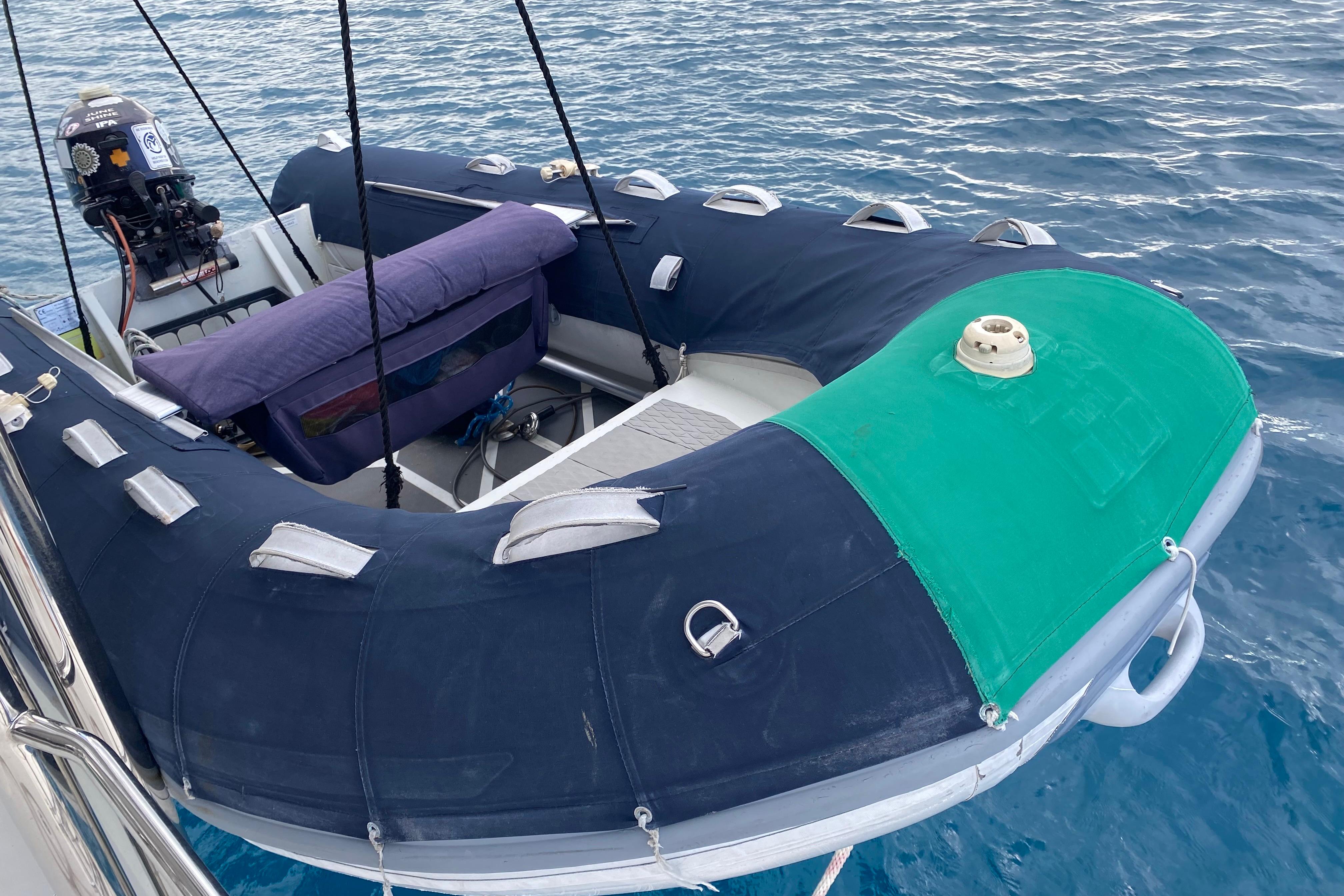 Inflatable boat with motor, docked on water, Leopard 40, 2017 model.