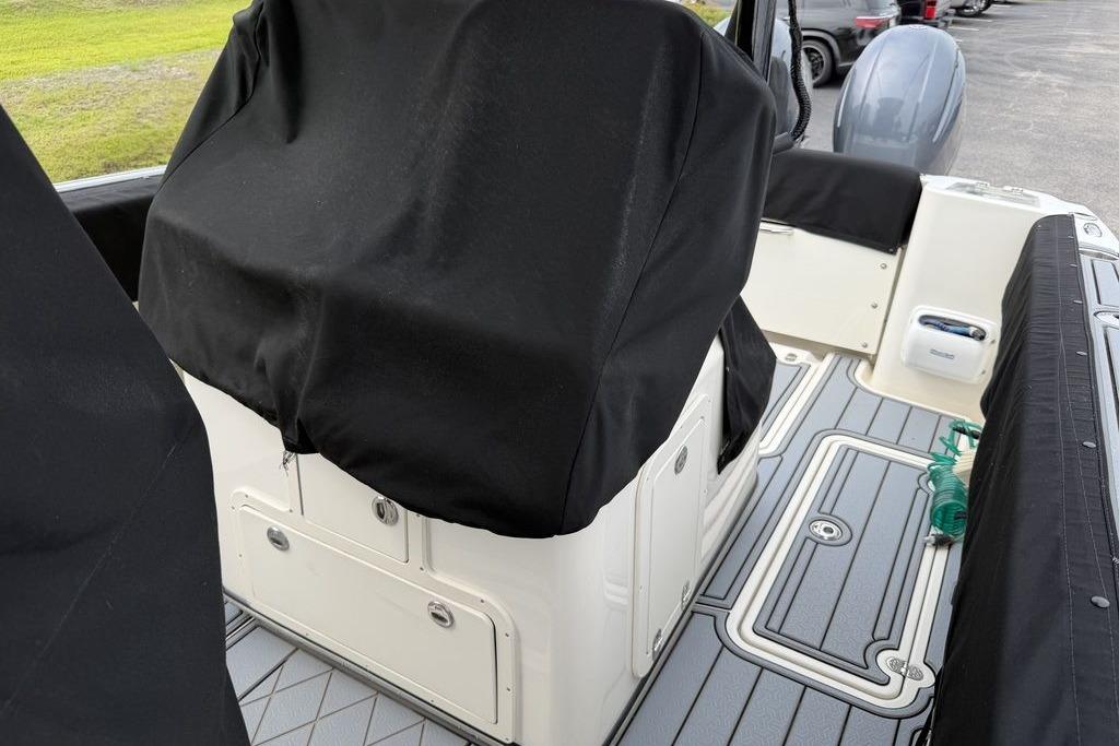 2023 Stingray 273 CC boat interior with covered seating and sleek flooring design.