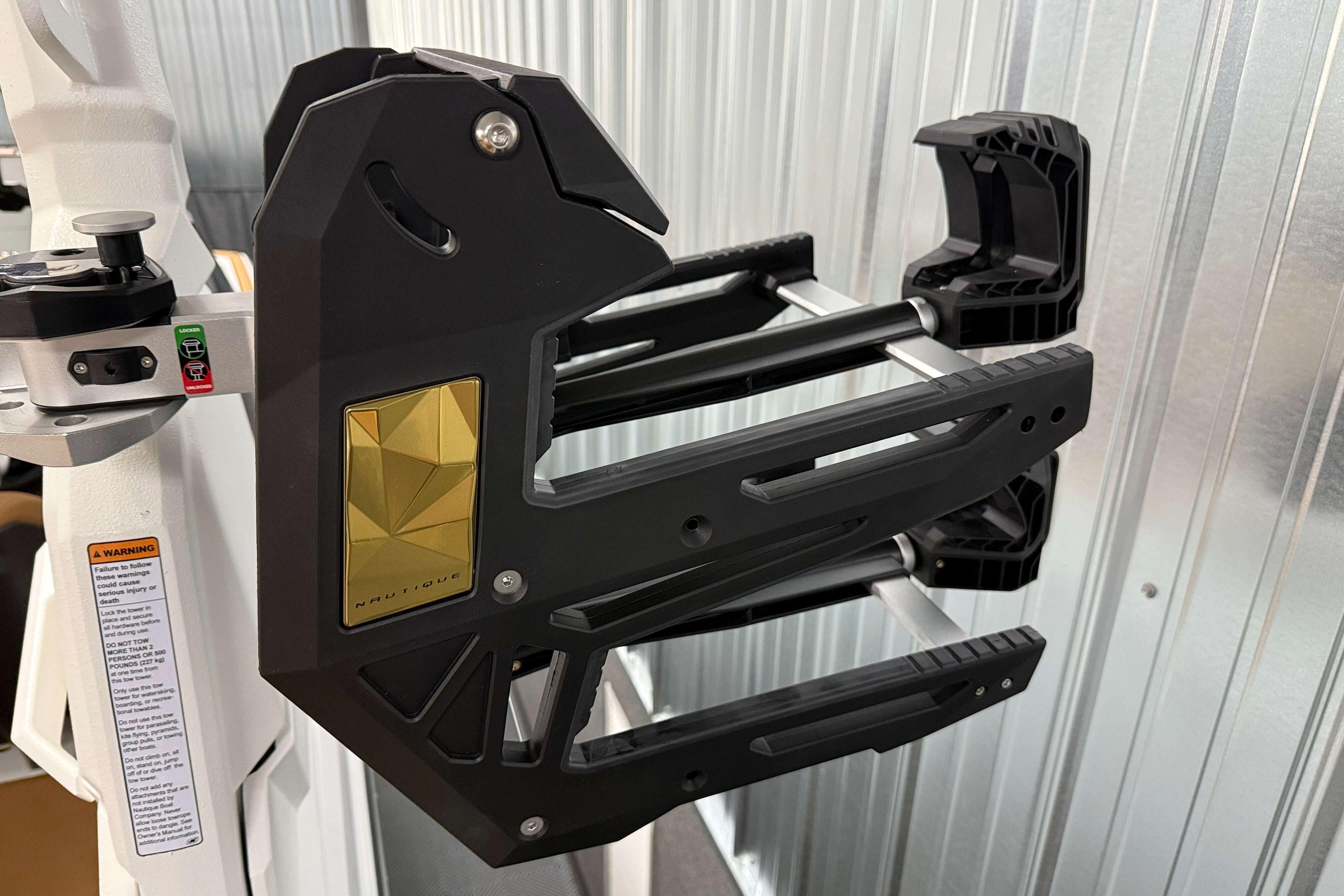 2026 Nautique Super Air Nautique S23 wakeboard rack, featuring sleek black and gold design.