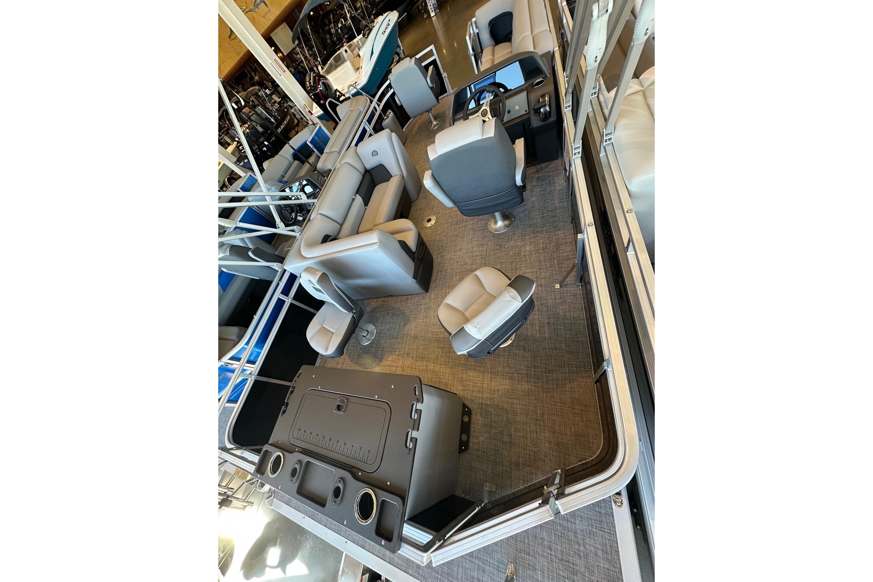 2026 Sun Tracker Fishin' Barge 20 DLX interior with seating and helm station.