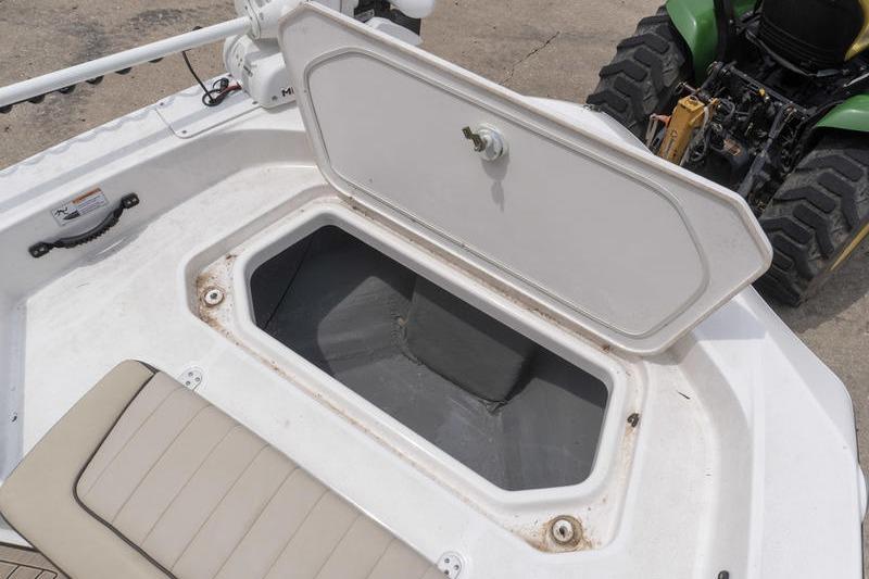 Open storage compartment on 2023 Yamaha Boats 195 FSH Sport, showcasing interior space.