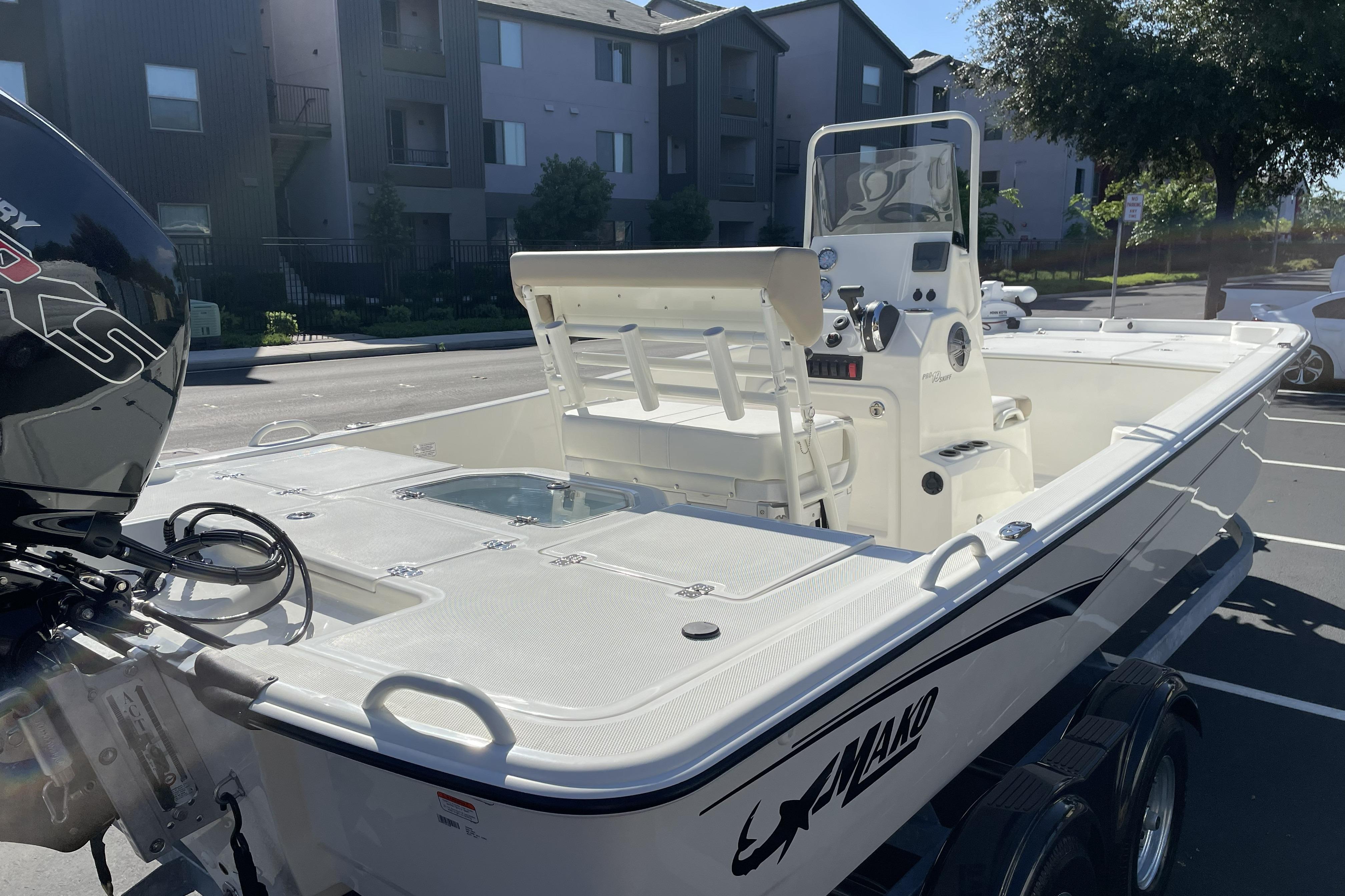 2026 Mako Pro Skiff 19 CC boat in a parking lot, showcasing sleek design and modern features.