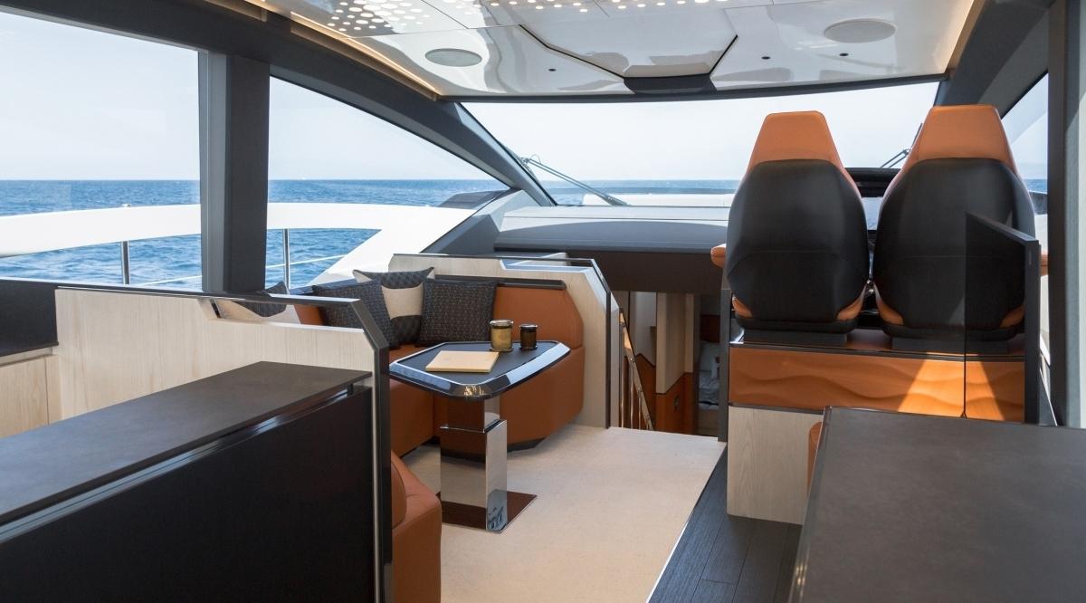 Luxurious interior of 2025 Astondoa 677 Coupe yacht with modern seating and ocean view.