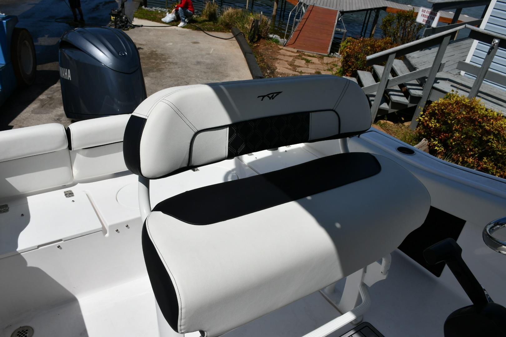 2023 Tidewater 210 LXF boat interior with cushioned seating and Yamaha engine.