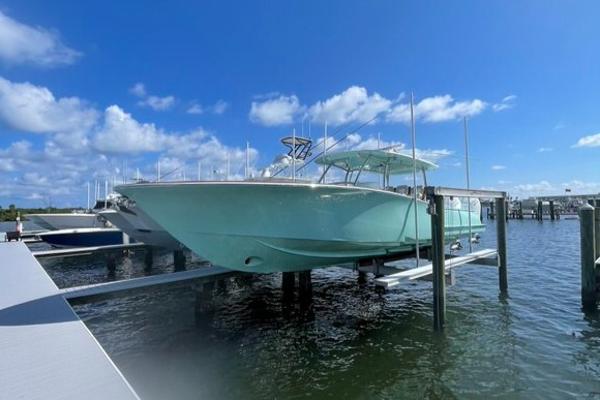 2025 Mag Bay 43 Center Console boat docked at marina under blue sky.