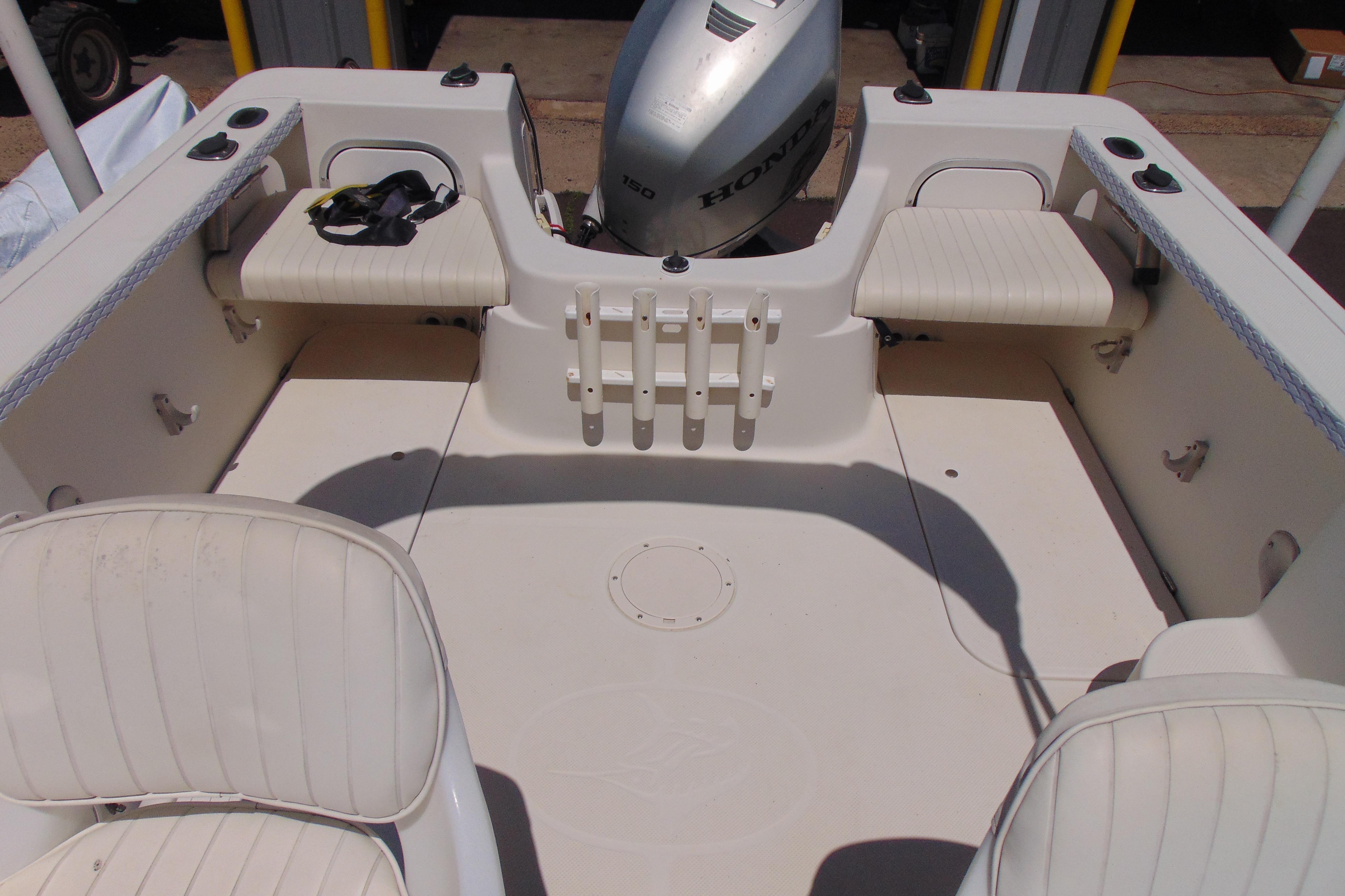 2002 Trophy Walkaround boat interior with seating and Honda outboard motor.