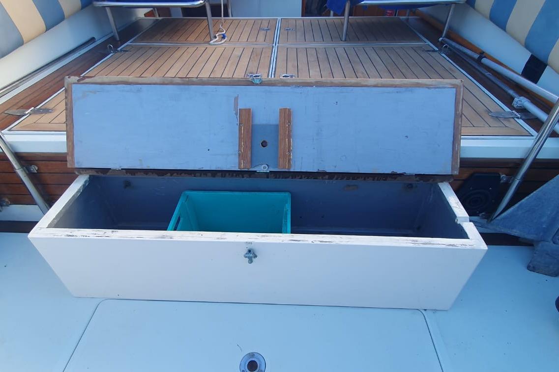 Open storage compartment on 1989 Fairey Spearfish MKIII boat with wooden deck.