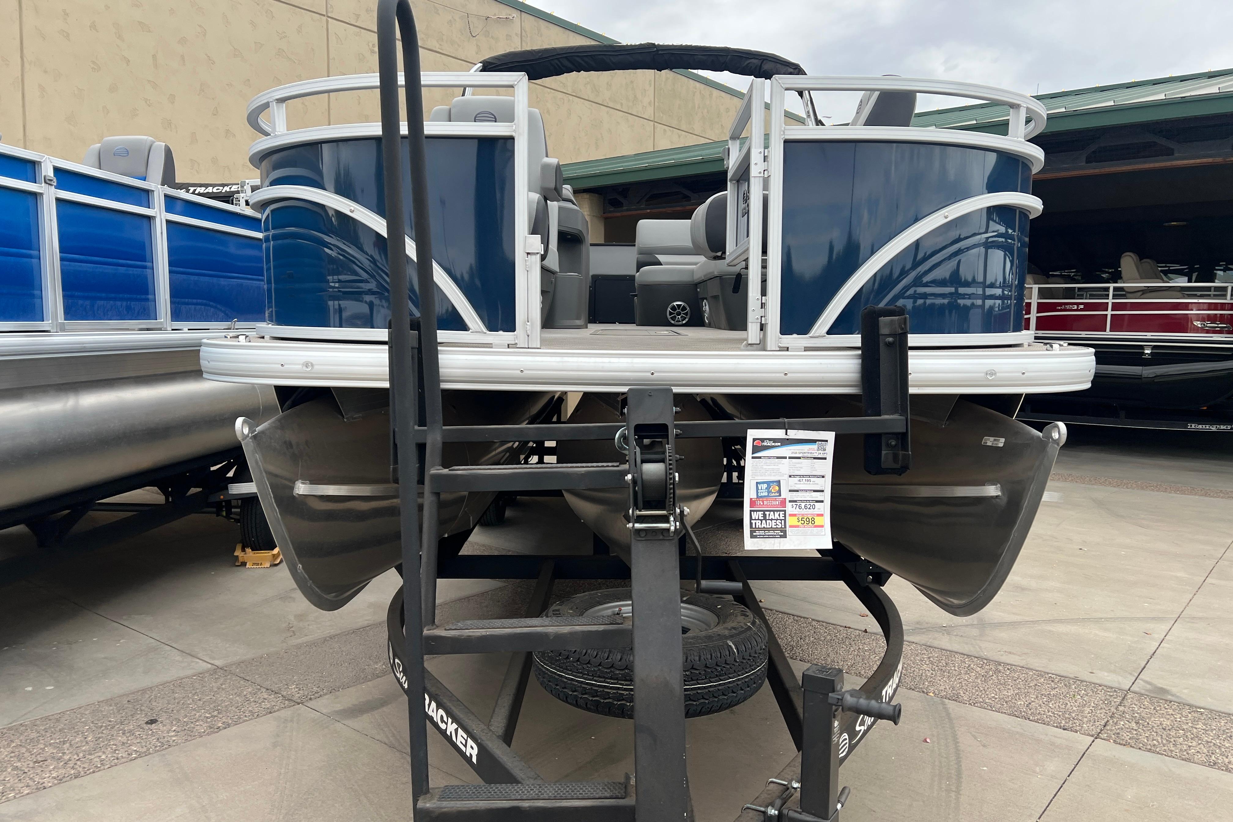 2026 Sun Tracker Sportfish 24 XP3 pontoon boat on display at a dealership.