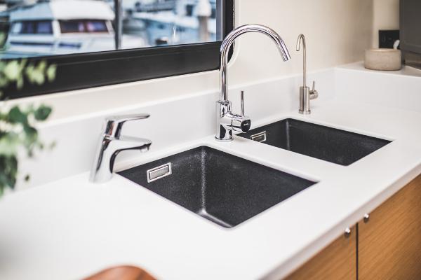 Modern kitchen sink with dual basins and sleek chrome faucets, Vision 444 model, 2025.