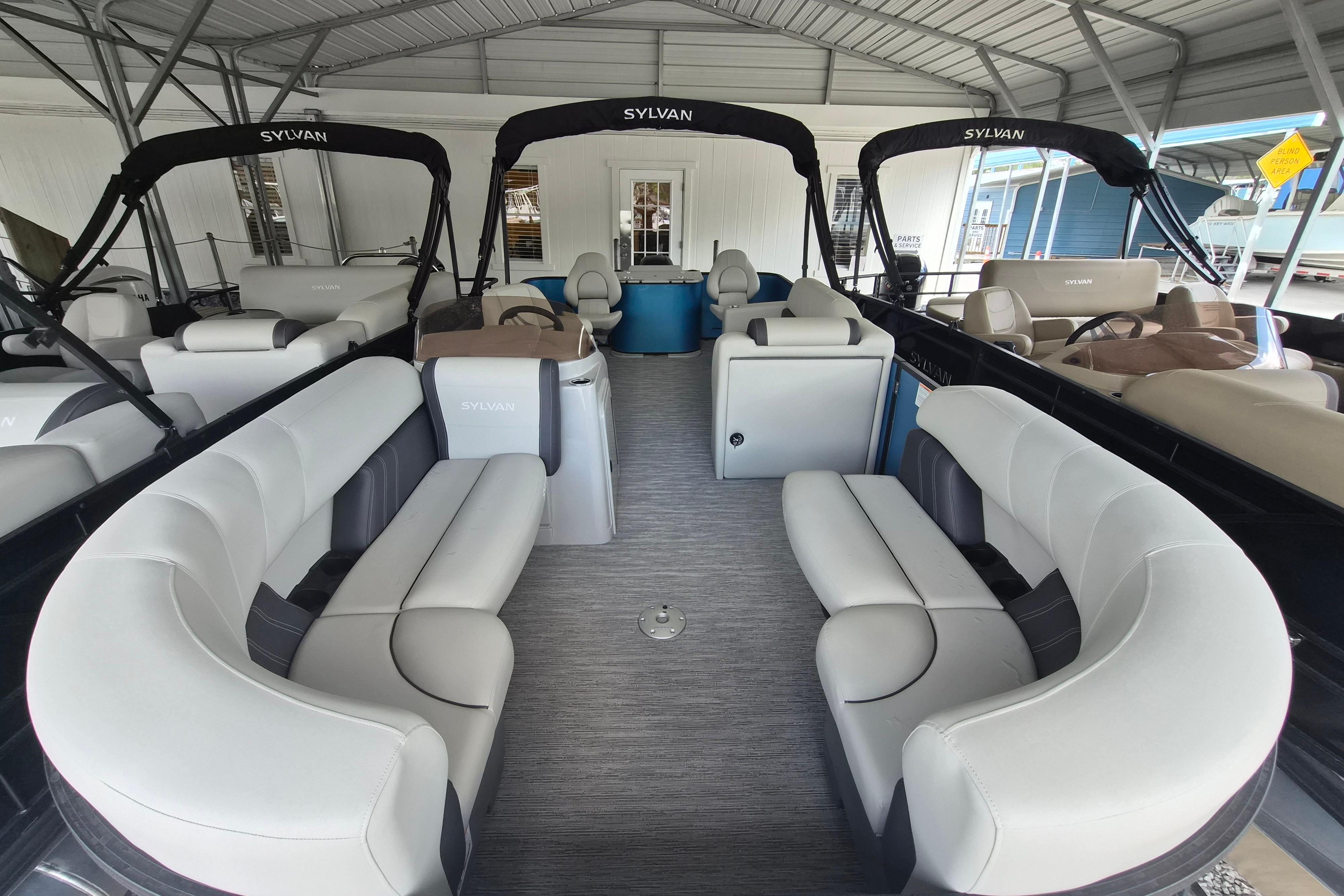 2026 Sylvan Mirage Fish 820 Party Fish pontoon boat with spacious seating under a canopy.
