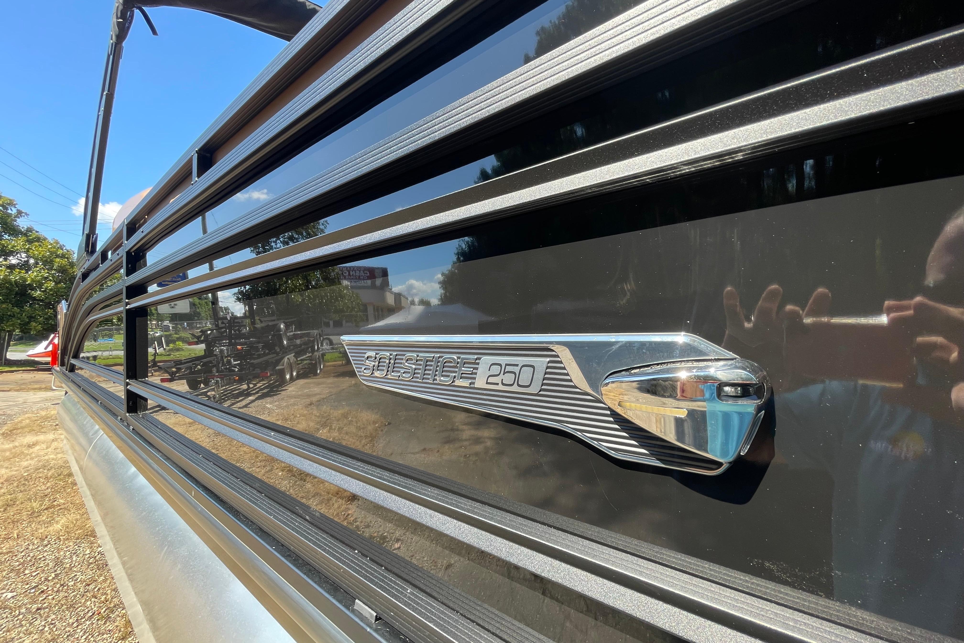 2026 Harris Solstice 250 SLDH pontoon boat, sleek black exterior with chrome detailing.