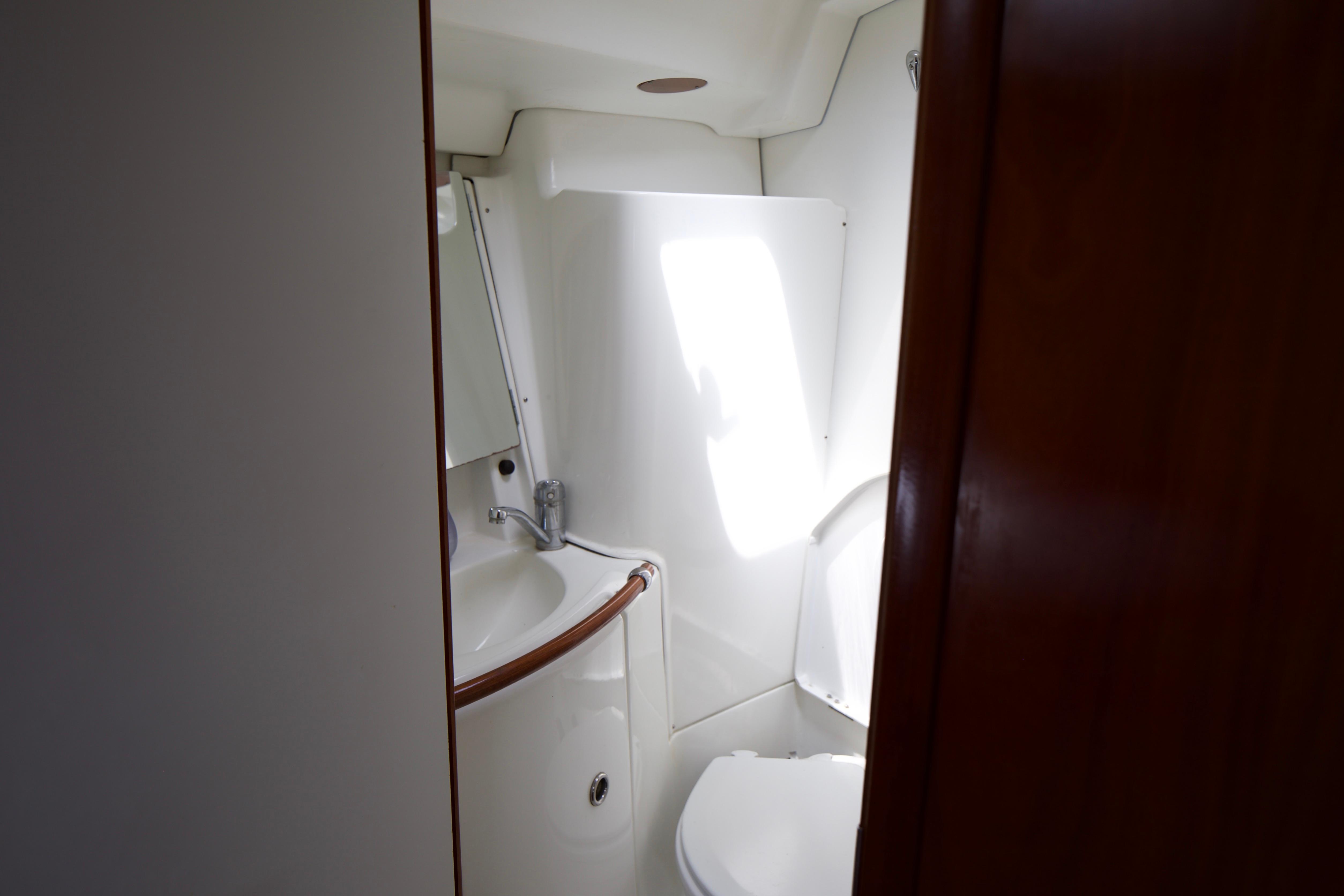 Bathroom interior of 2005 Beneteau 423 yacht, featuring compact design and modern fixtures.