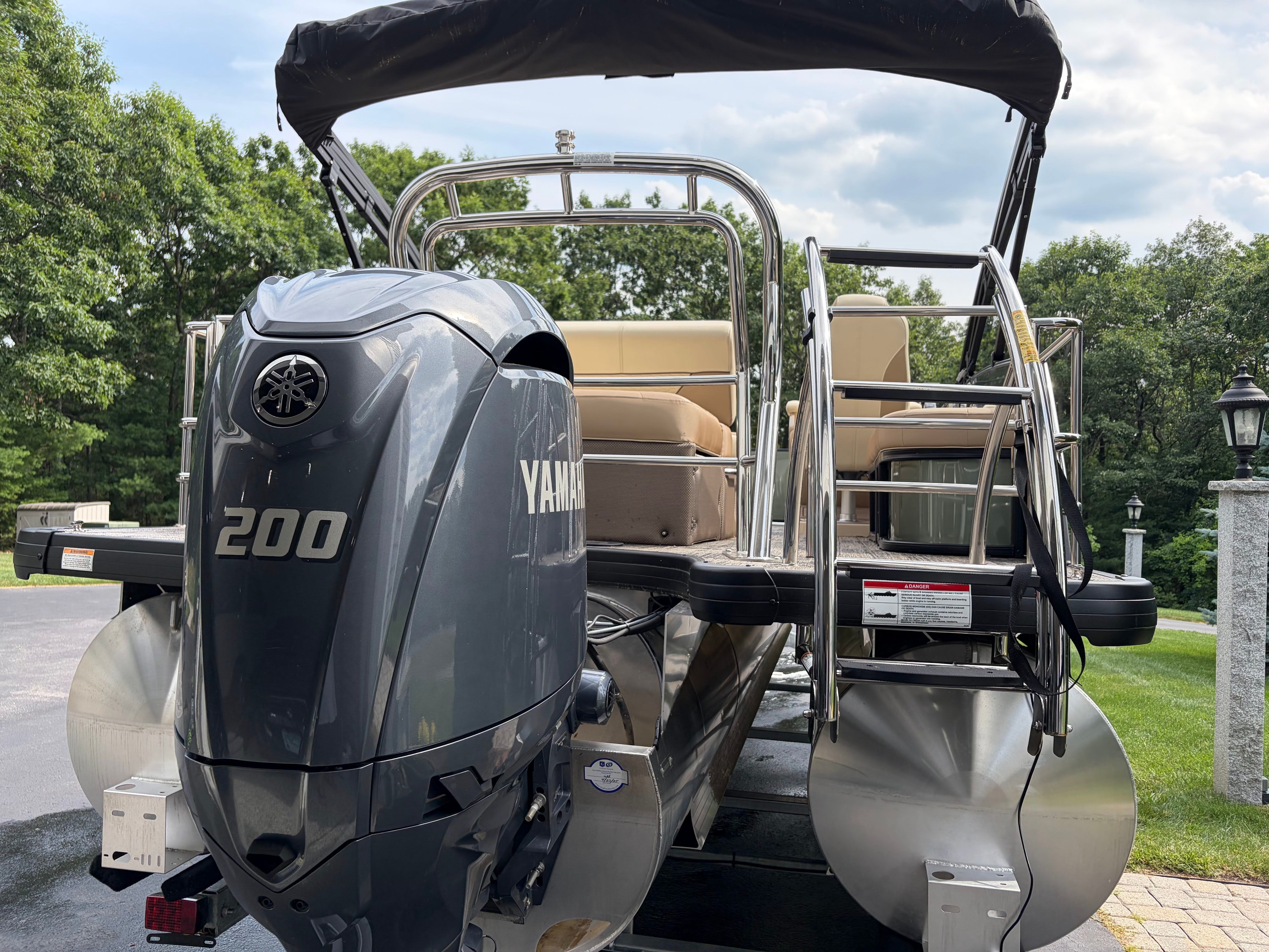 The image shows a 2025 Godfrey Monaco Cruise pontoon boat with a Yamaha 200 outboard motor.