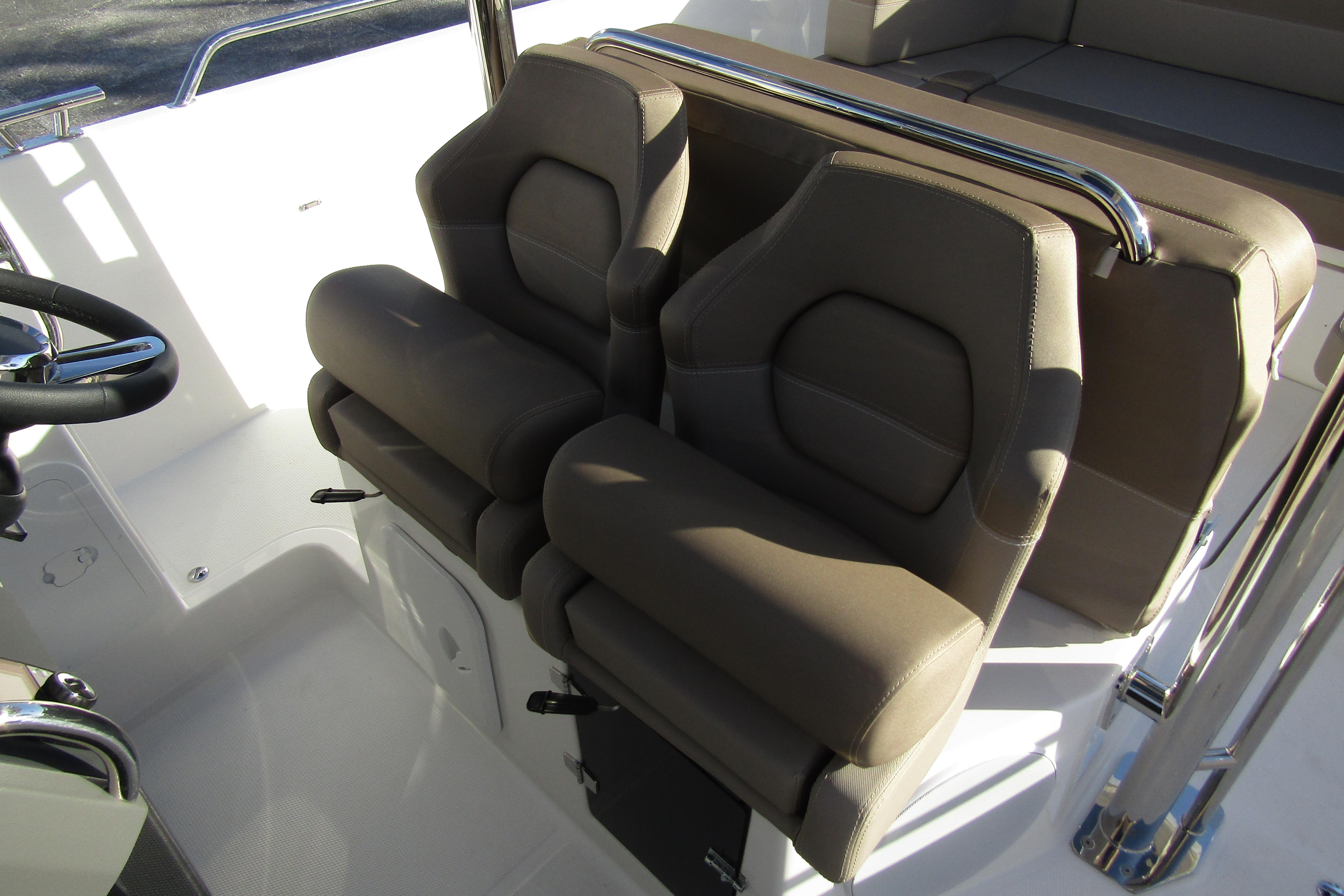 2025 Nimbus Tender 9 boat interior with dual brown seats and steering wheel.
