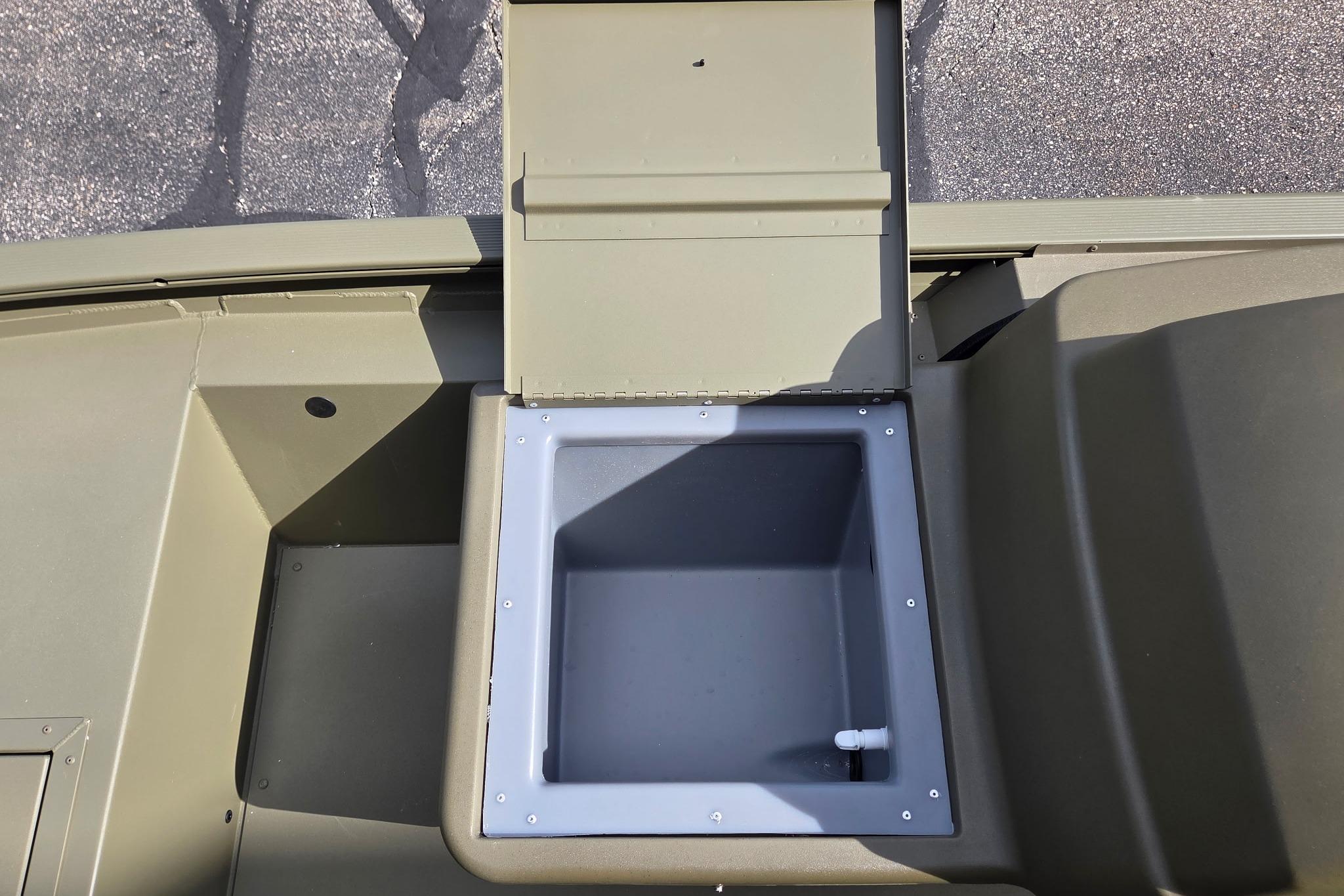 Open storage compartment on 2026 Tracker Grizzly 1754 SC boat, showcasing interior space.