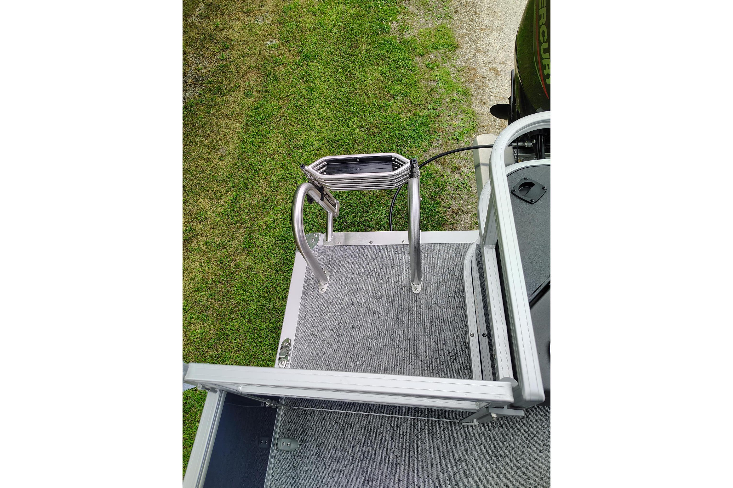 2026 Sun Tracker Bass Buggy 18 DLX boat ladder and deck, viewed from above.
