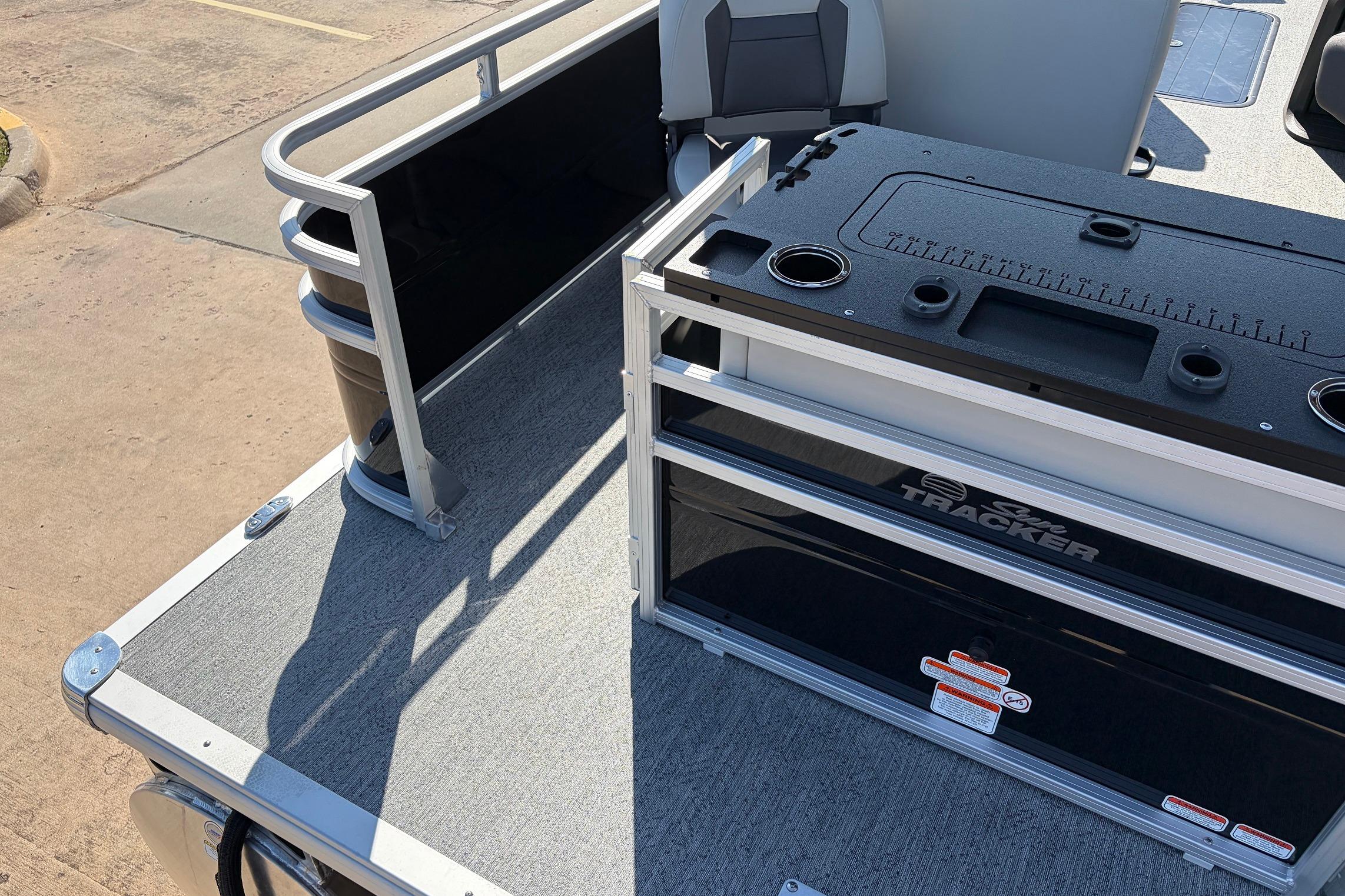 2026 Sun Tracker Fishin' Barge 22 XP3 deck with seating and storage compartments.